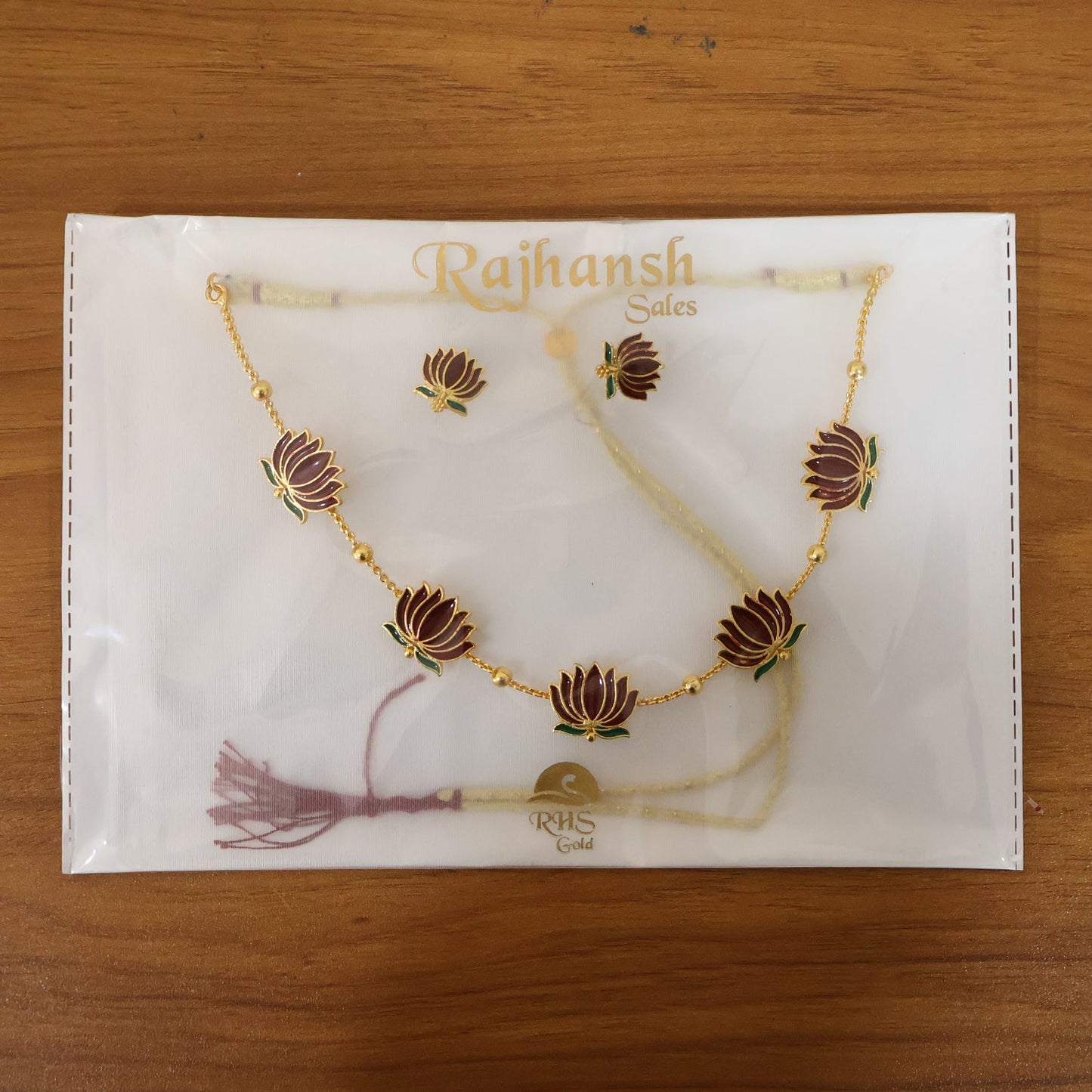Stud earrings matching lotus design necklace in ethnic jewellery collection