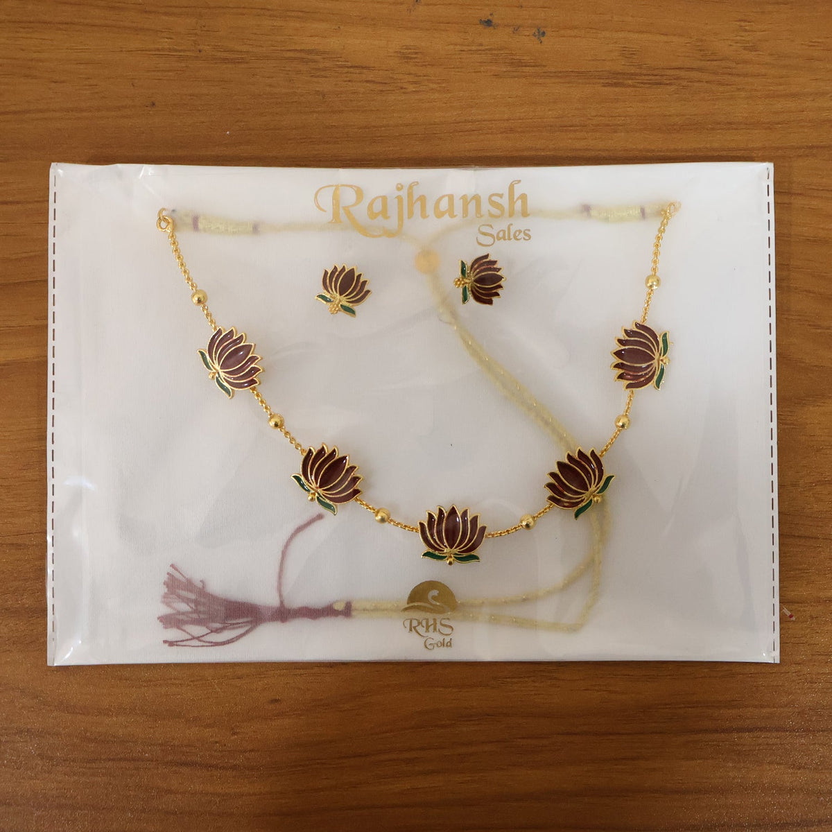 Stud earrings matching lotus design necklace in ethnic jewellery collection