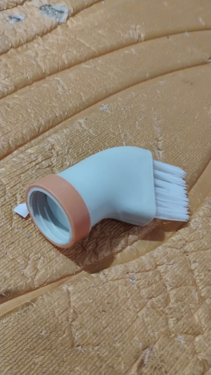 Packaged bottle-attachable crevice cleaning brush ready for purchase