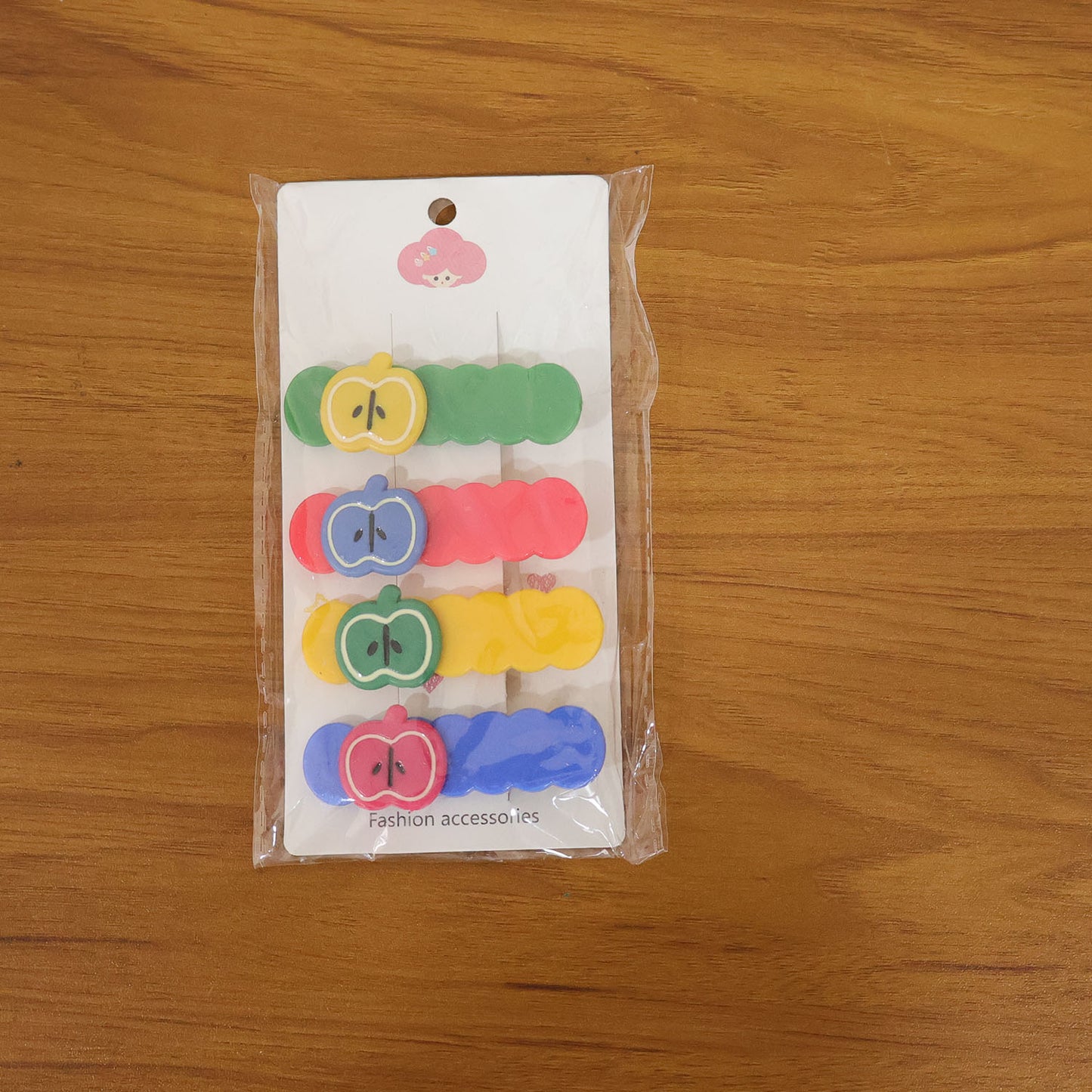 Lifestyle image of girl wearing colorful apple design hair clip set hair accessories