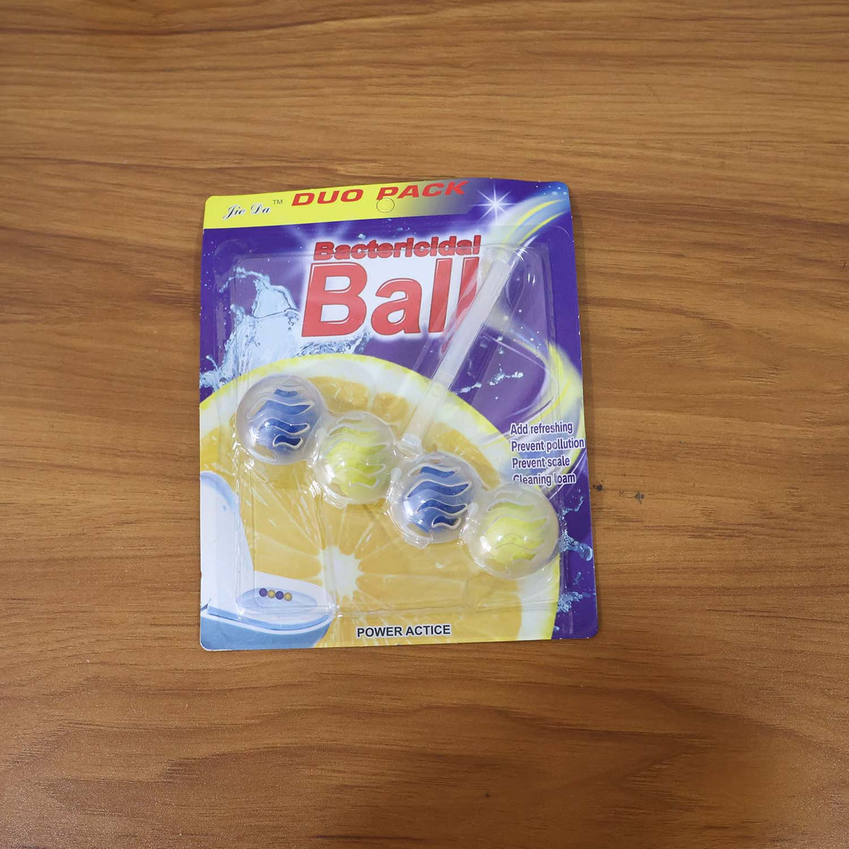 Packaged toilet cleaning balls with a lemon graphic and text 'Bactericidal Ball' on a wooden surface.