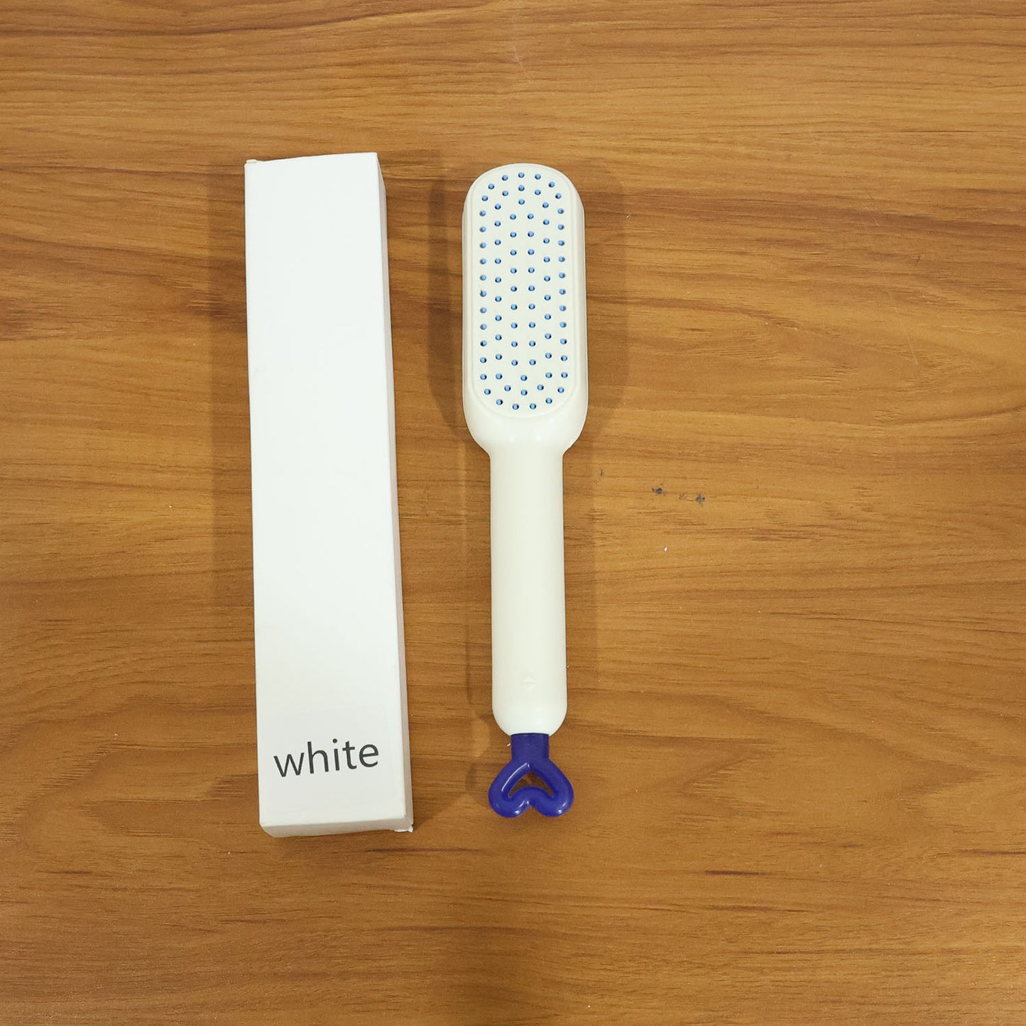 Live photo of the self cleaning massage hair comb