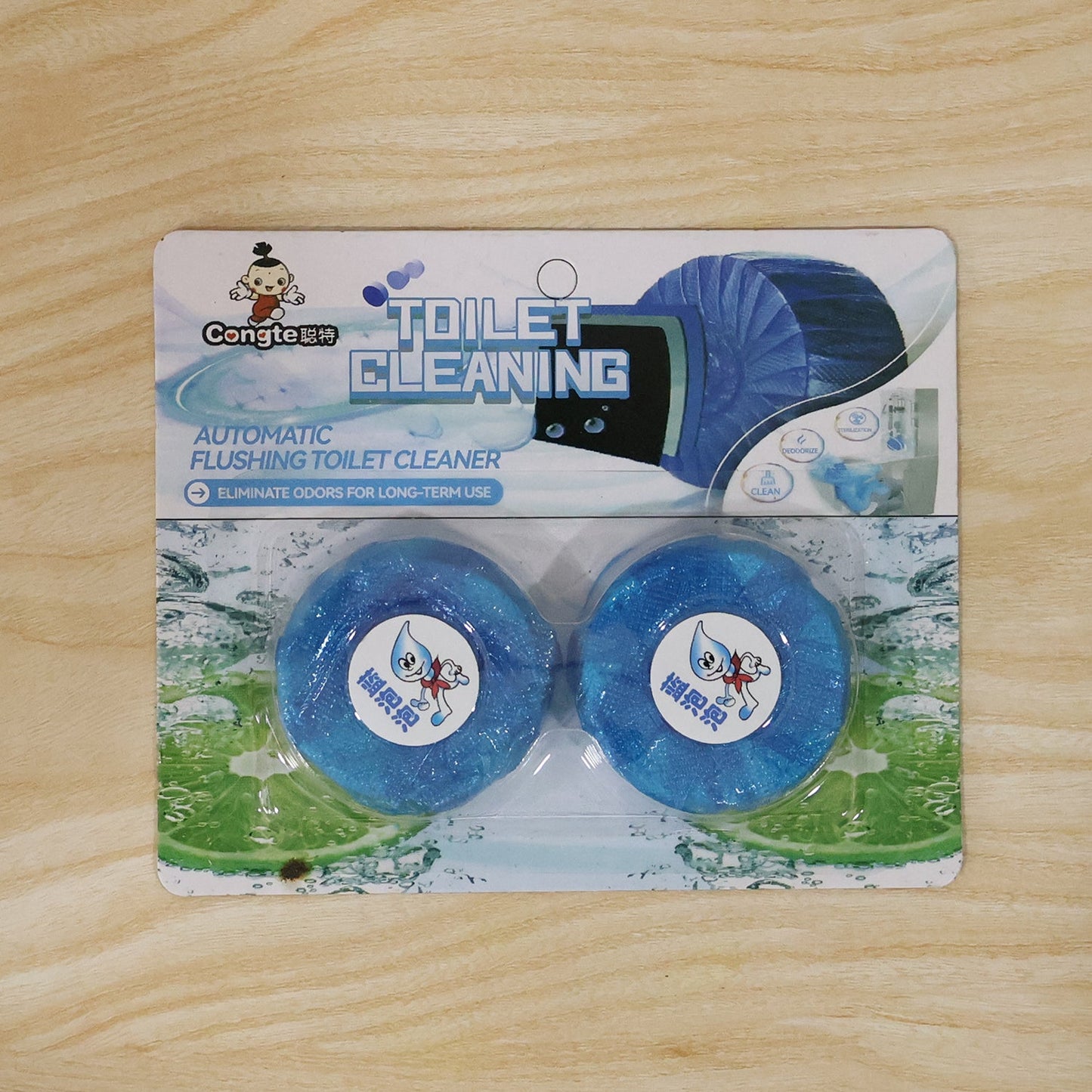 Two blue toilet cleaner tablets in blister packaging, labeled "Toilet Cleaning," on a wooden surface.