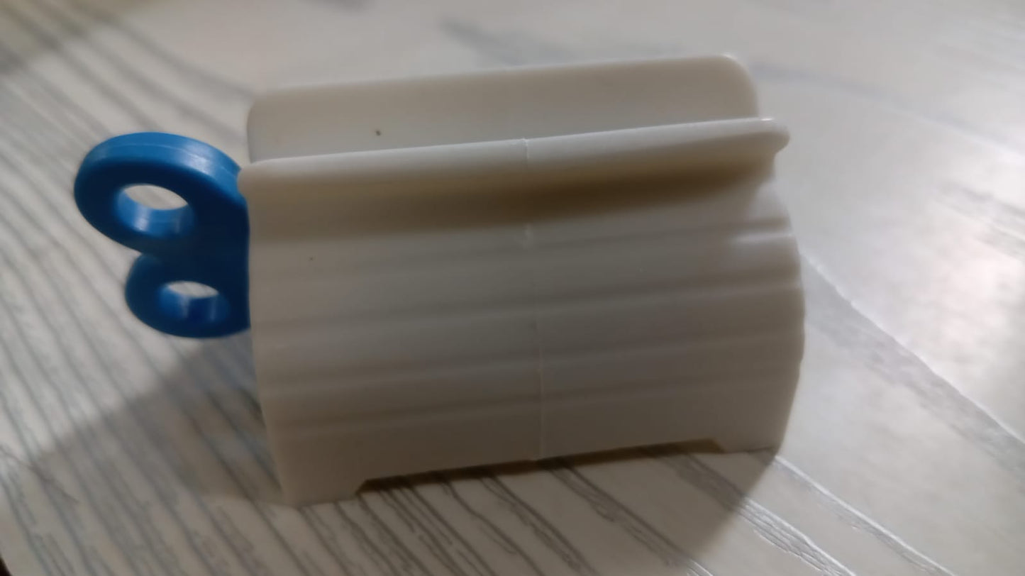 Plastic tube squeezer with its seat holder, emphasizing convenience and organization for bathroom essentials.