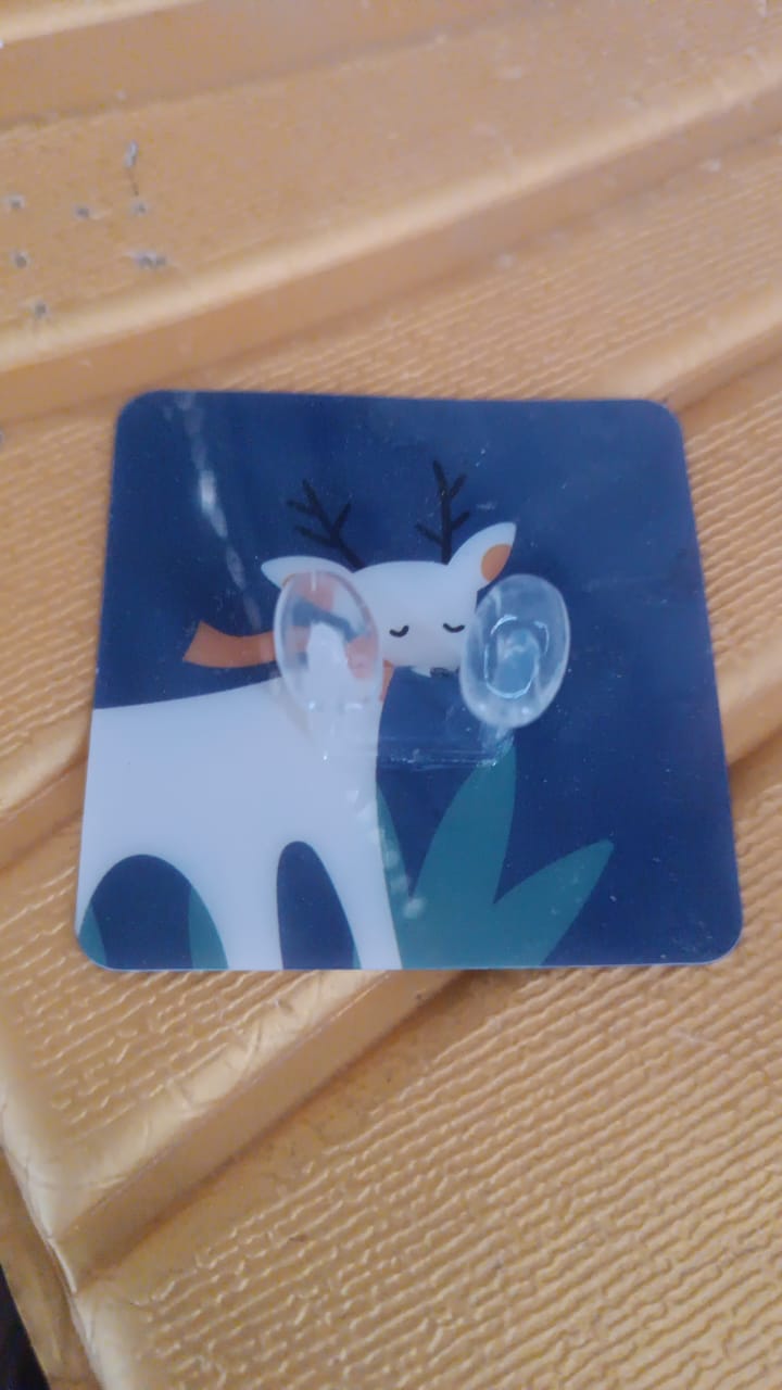 Deer design self-adhesive wall hook installed on a living room wall for organisation.