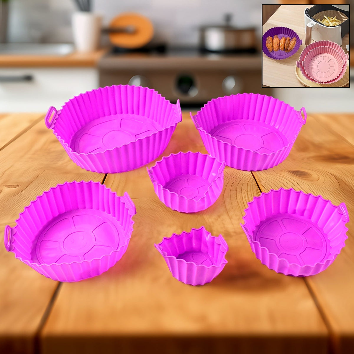 Five purple silicone air fryer pots with handles in various sizes on a wooden kitchen counter