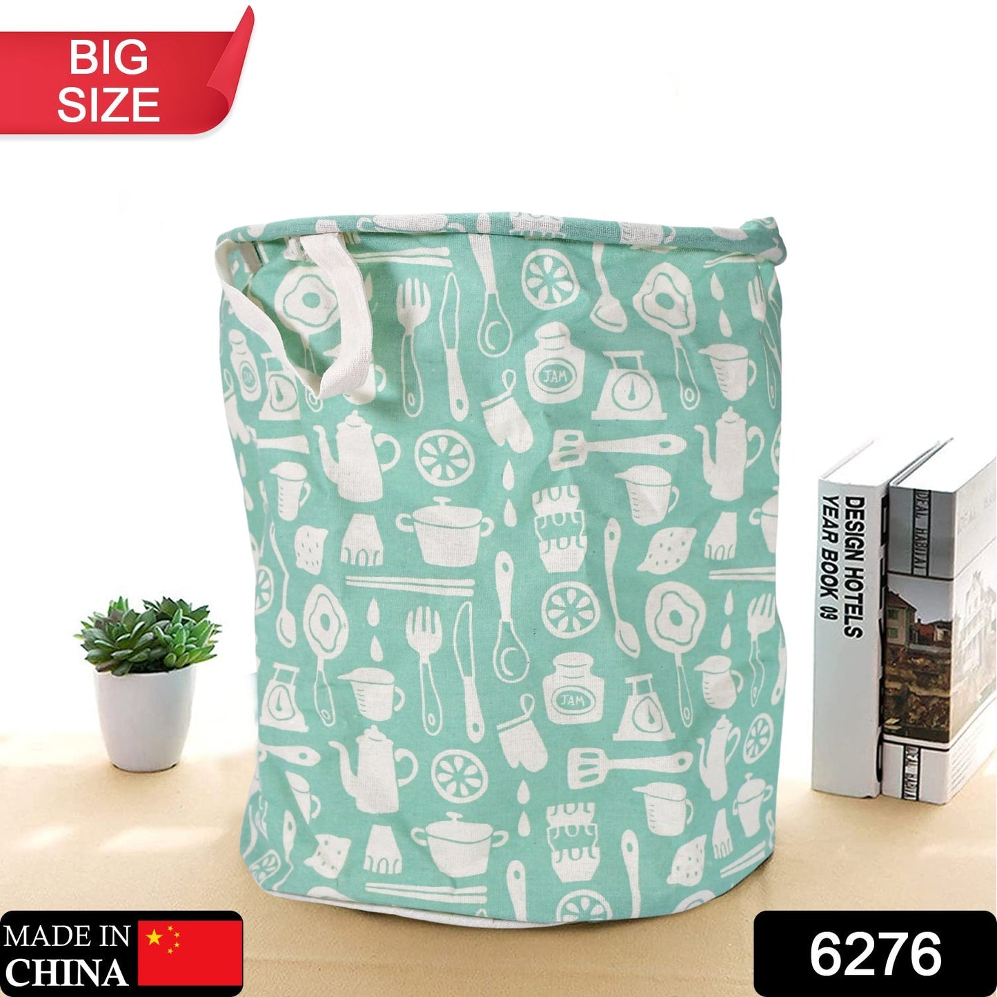 Mint green collapsible laundry hamper with white kitchen utensil pattern on a white background.