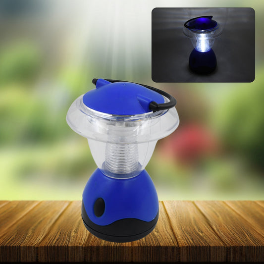 Indo Glow Mini Camping Lantern hanging from a tent pole, illuminating a campsite at dusk.
