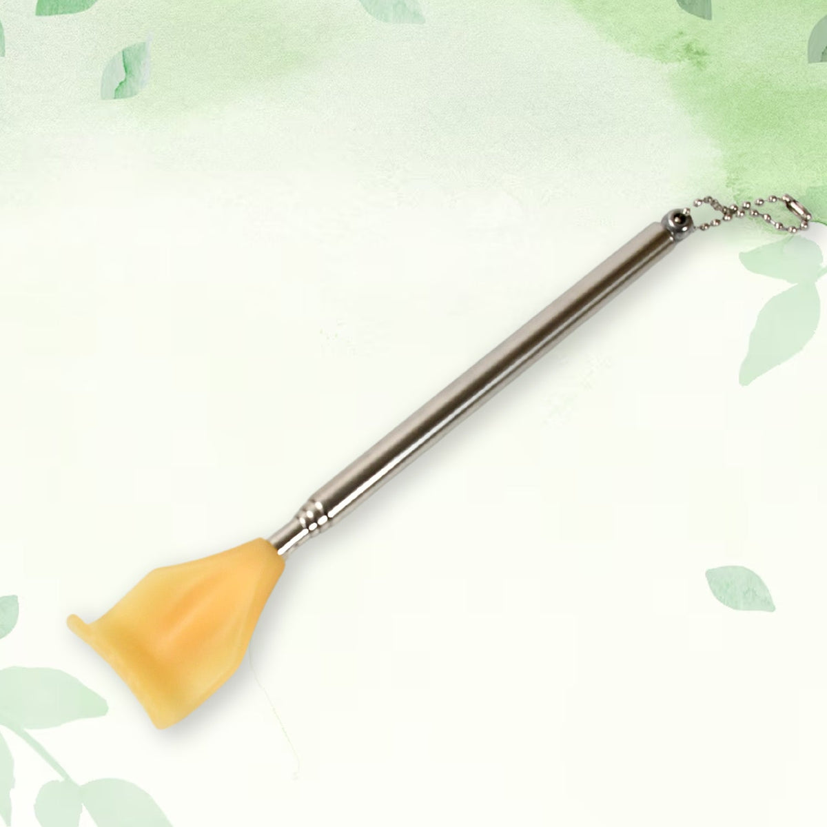 A silver telescoping back scratcher with a yellow hand-shaped head and a ball chain attached to the handle, against a green