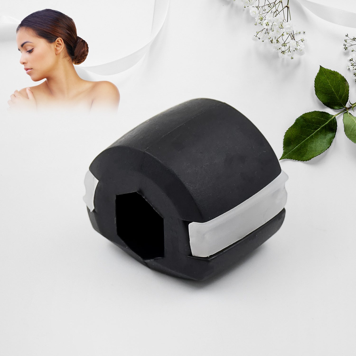 A black and white jaw exerciser on a white background with a woman's face and green leaves.