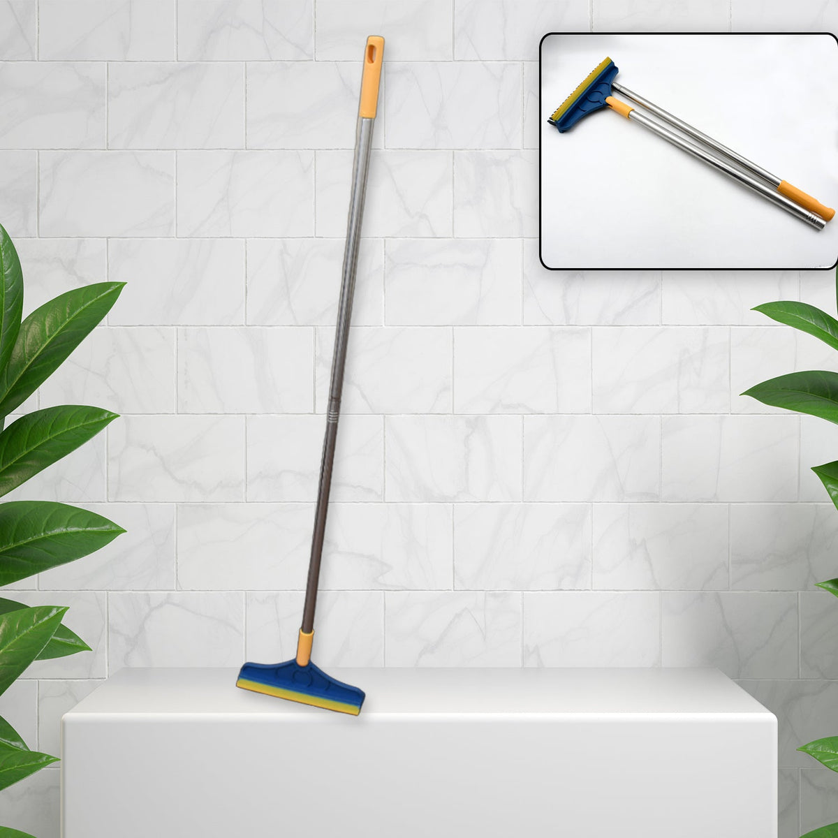 Blue and yellow floor cleaning brush with long handle on a white pedestal, with a close-up of the brush head and handle.