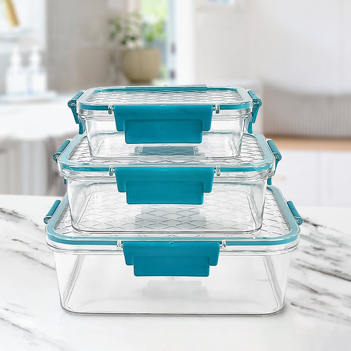 Three clear rectangular food containers with teal locking lids are stacked on a white marble surface.