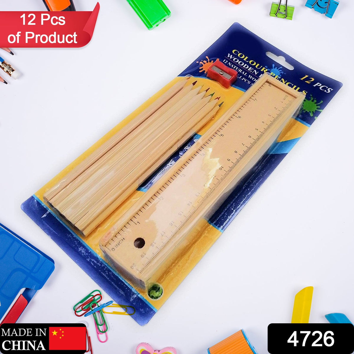 The 12-piece wooden colored pencil set, ruler, and sharpener are shown in their clear plastic packaging on a desk with