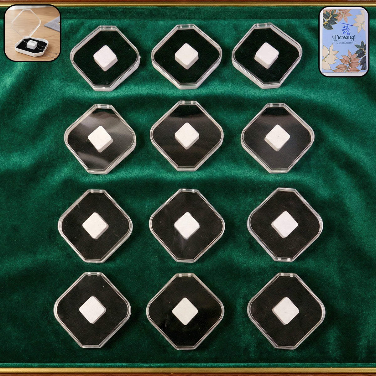 Twelve clear and black jewellery boxes with white cushions, arranged on a green velvet surface.