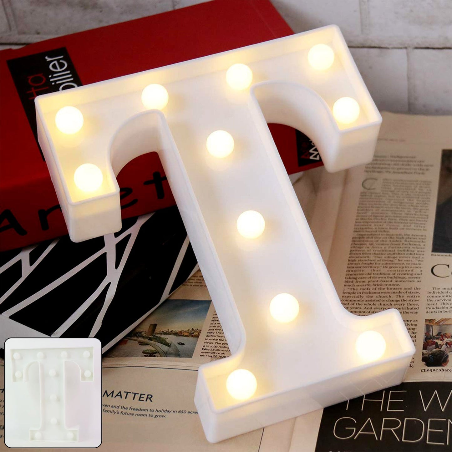LED Marquee Alphabet Letter Light T glowing softly on table