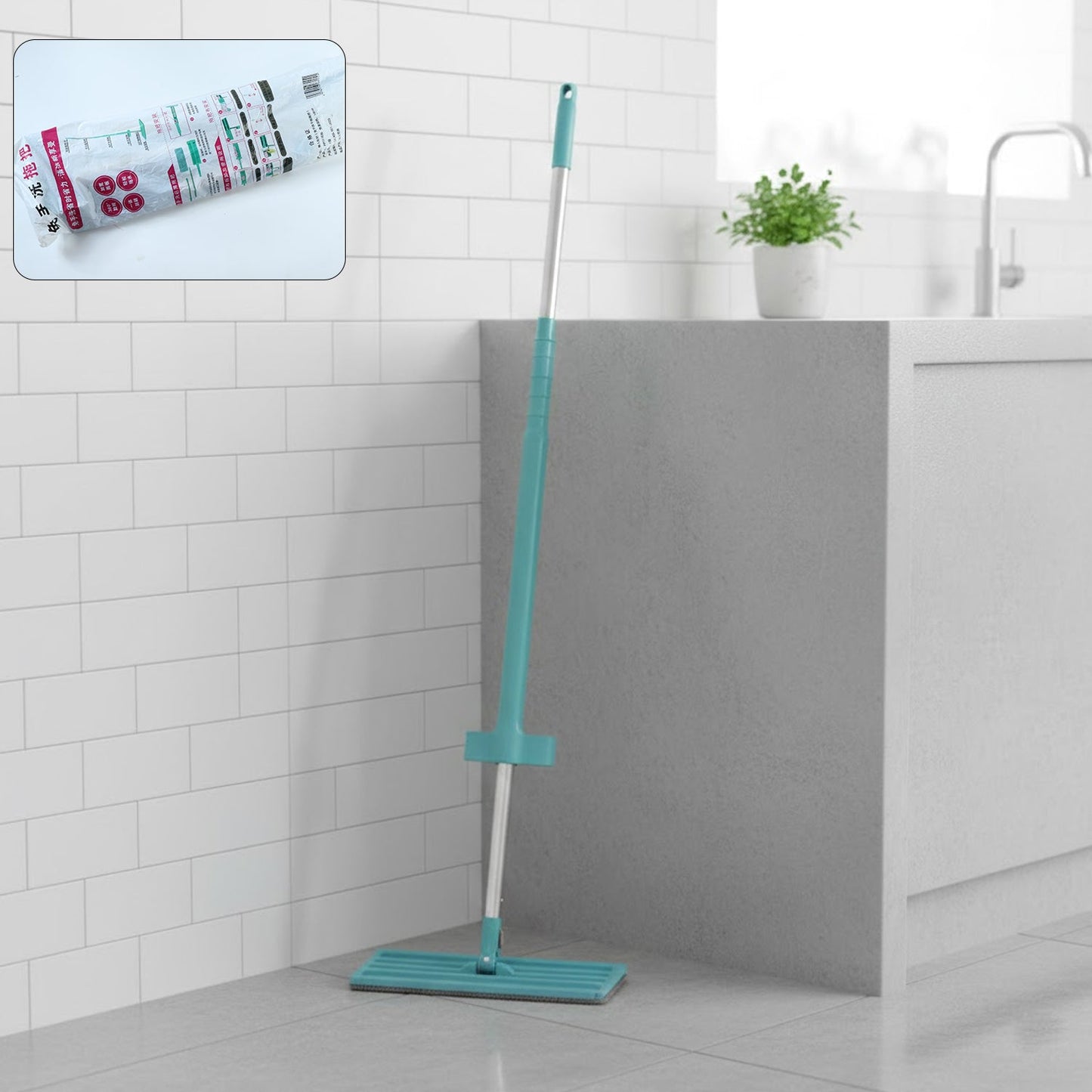Flat floor cleaning mop with long handle and rectangular mop head on floor