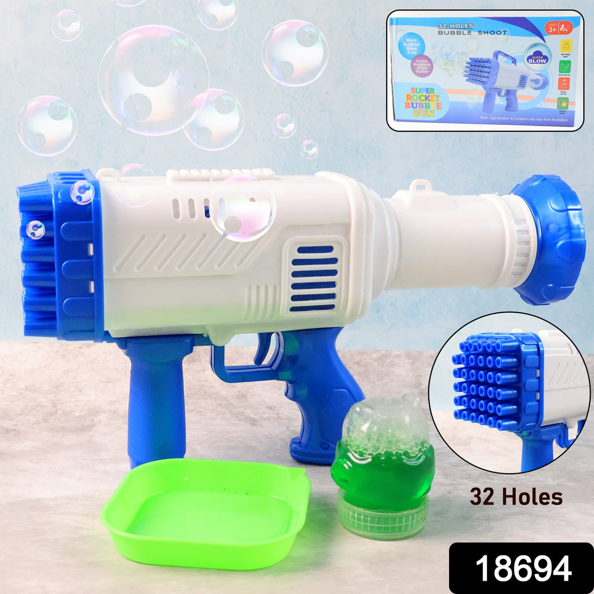 A white and blue 32-hole bubble gun with a green tray and bubble solution, with product packaging in the corner.