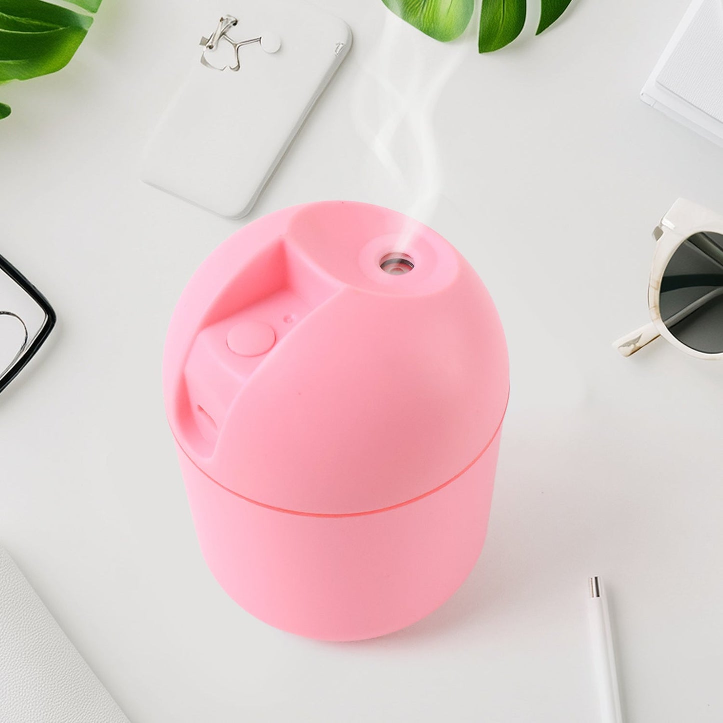 USB Mini Air Humidifier on desk emitting cool mist with soft LED light