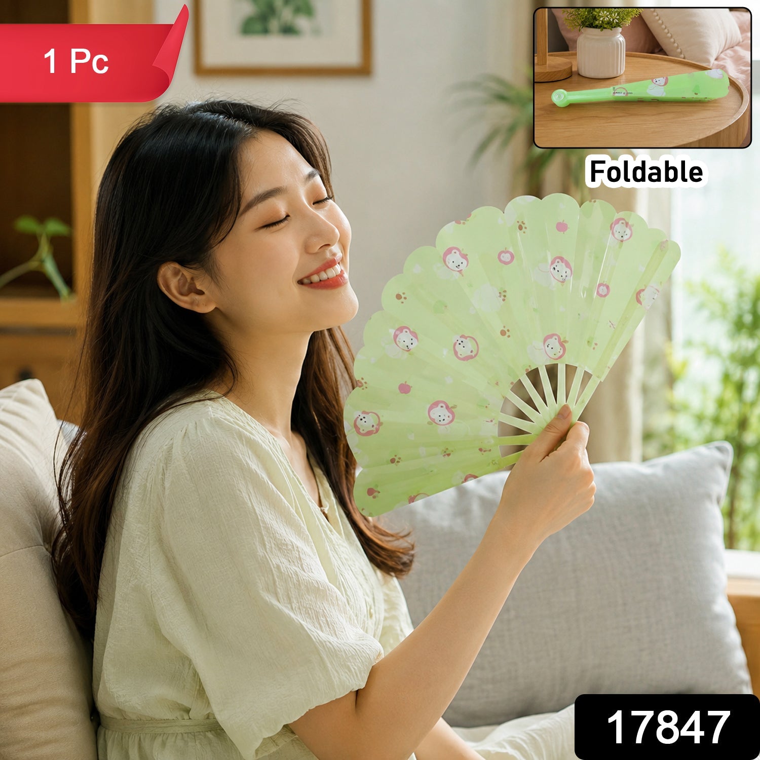 A woman in a light dress sits on a sofa, fanning herself with a green plastic fan, with product details overlaid.