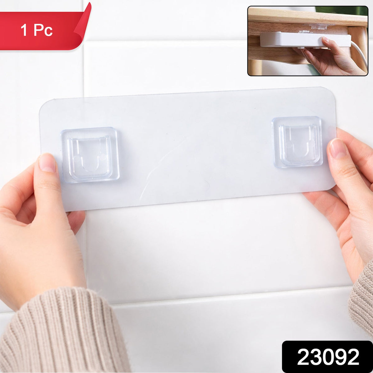 Hands hold a clear plastic self-adhesive hanger against a white tiled wall, with an inset showing its use.
