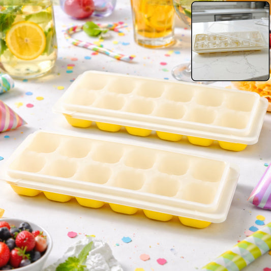 Two yellow silicone ice cube trays with clear lids on a confetti-strewn table with drinks. The inset shows one tray from