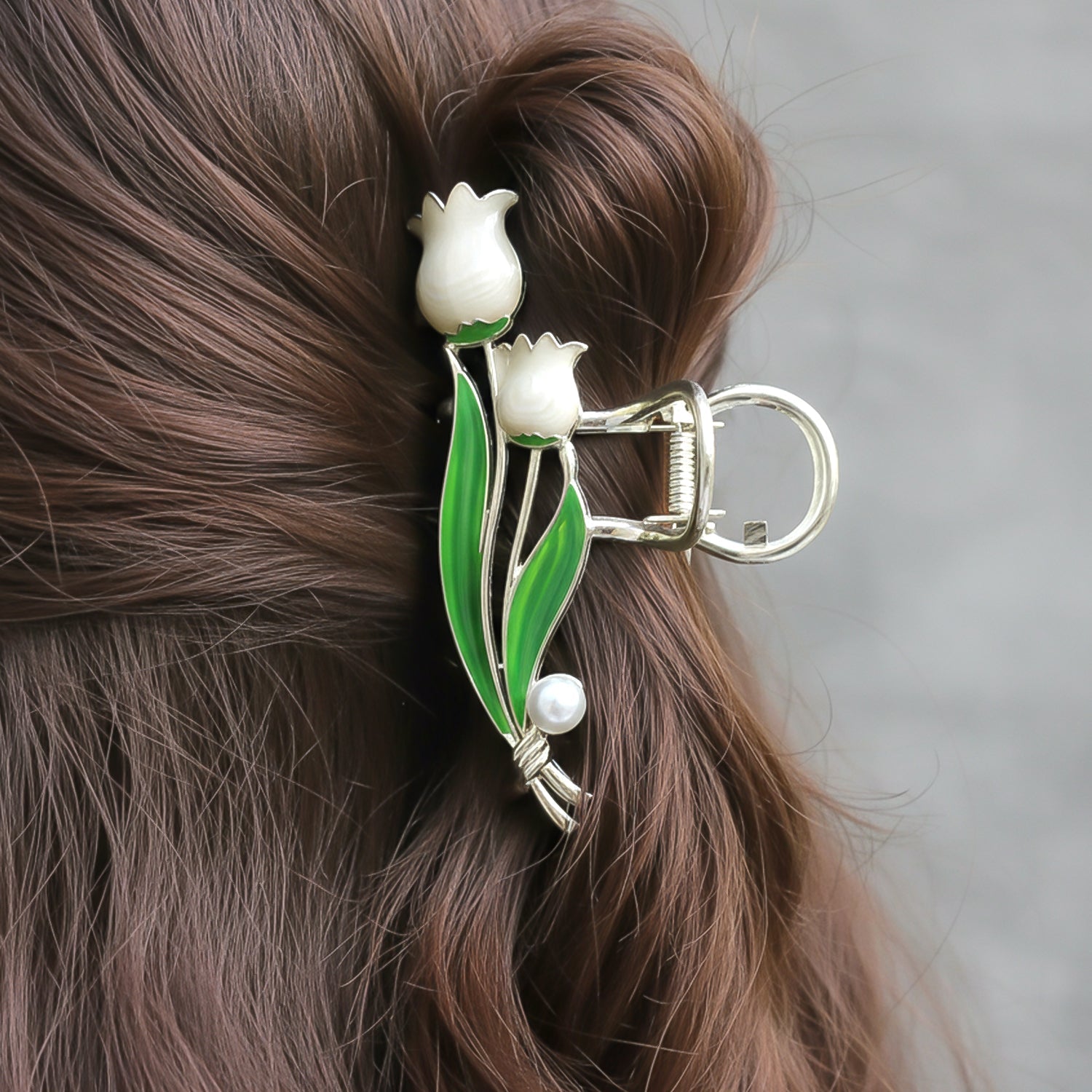 Close-up of floral hair clip with pearl accent for secure styling