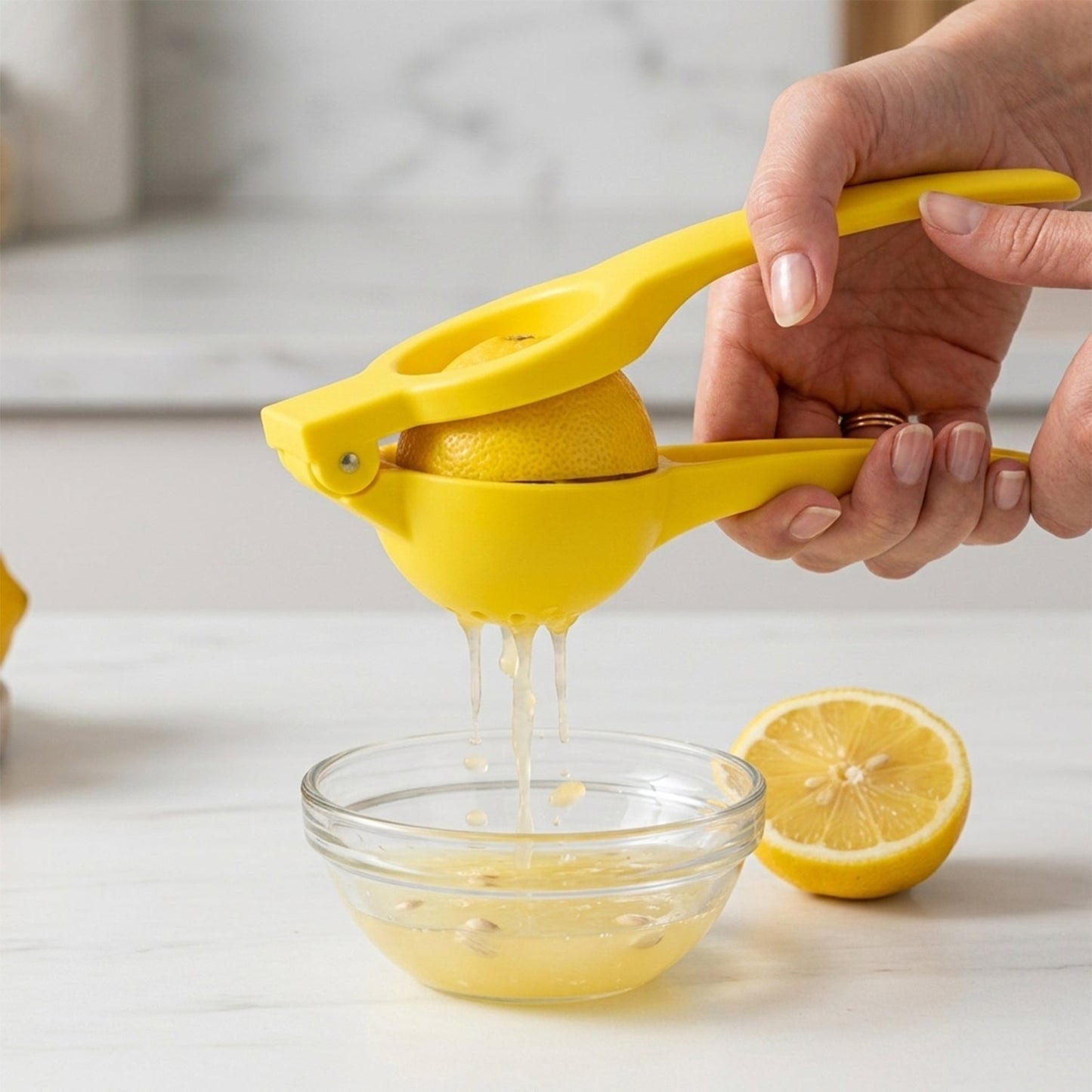 A vibrant yellow manual lemon squeezer with an open bowl and handles on a white background.