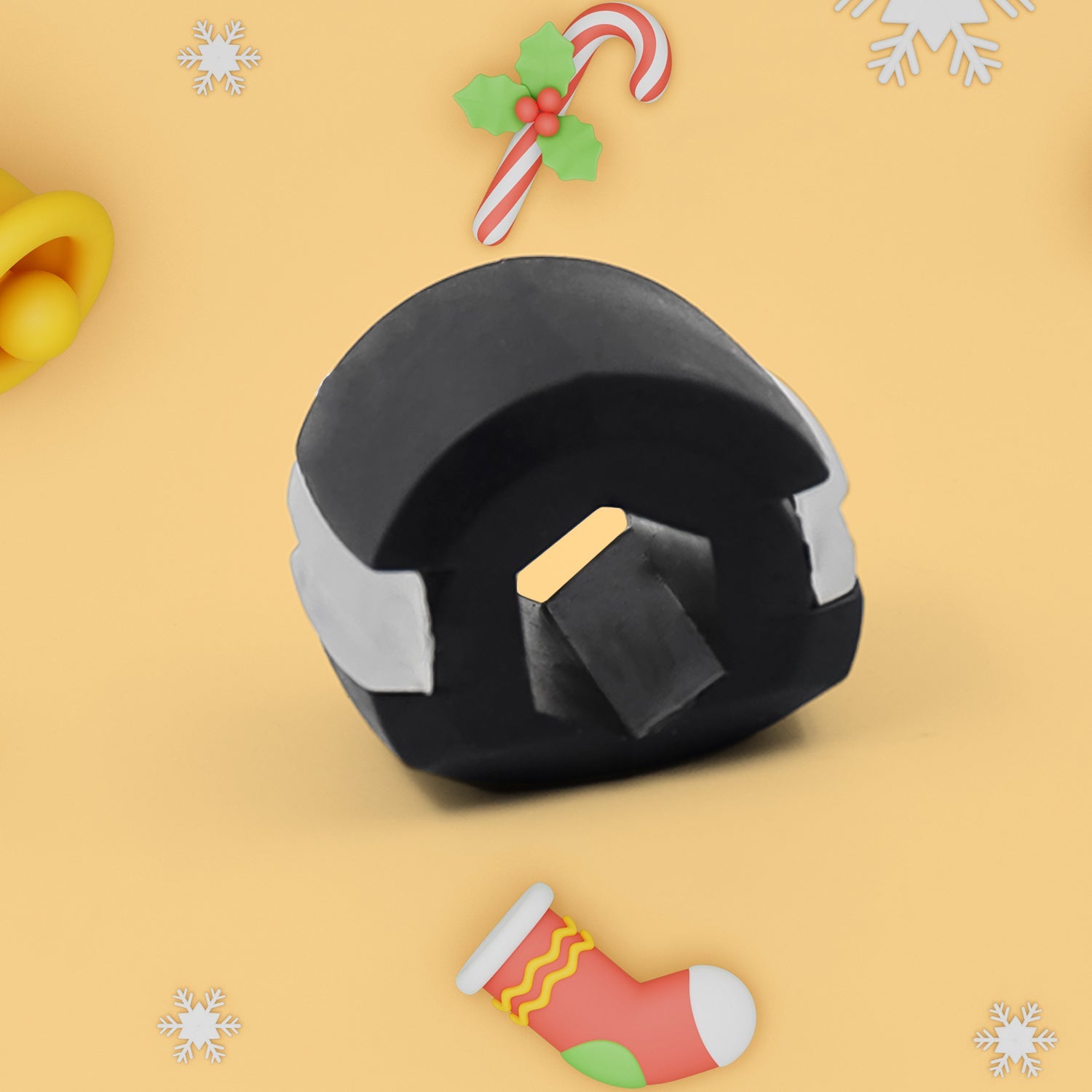 A black and white jaw exerciser with a yellow accent on a yellow background with Christmas-themed decorations.