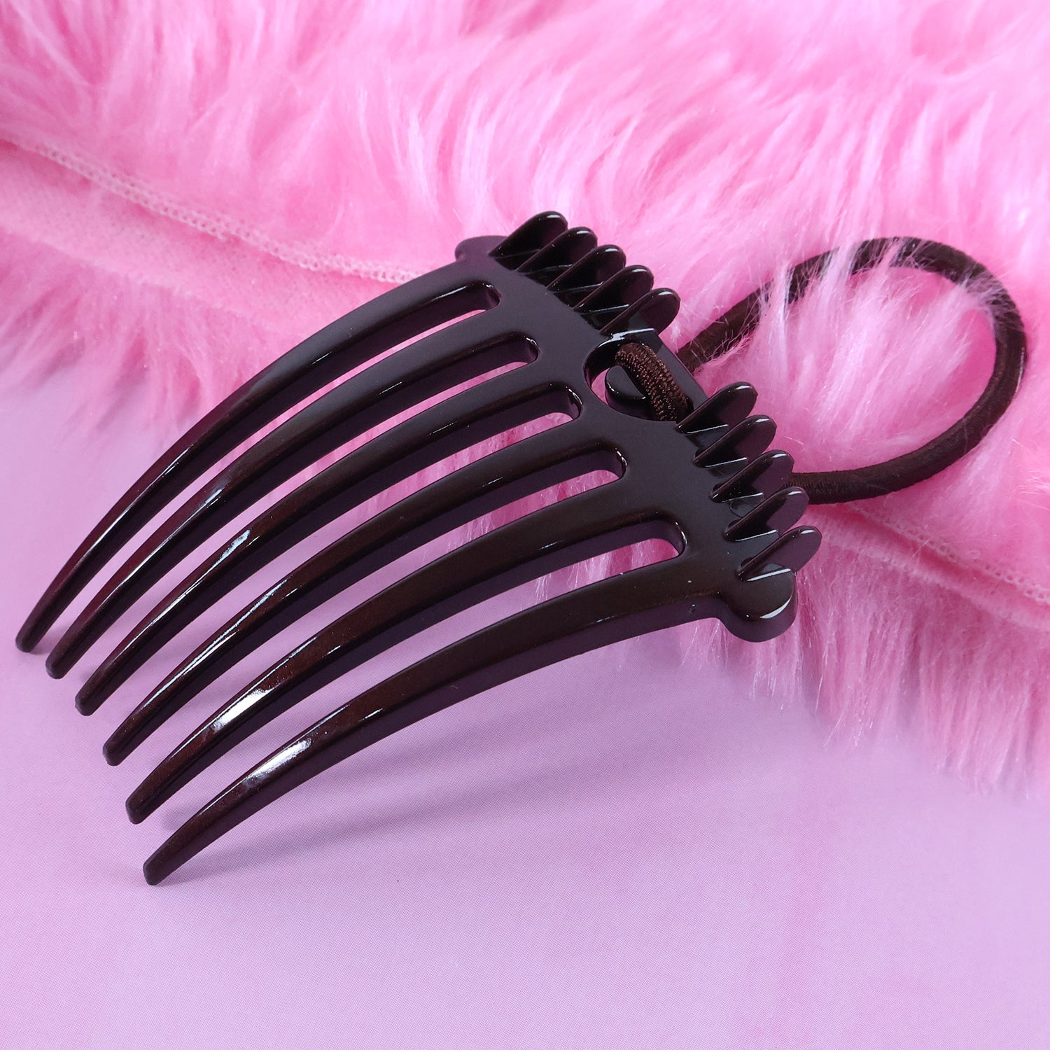 Detailed side profile of the Ponytail Comb, highlighting its robust construction and elastic.