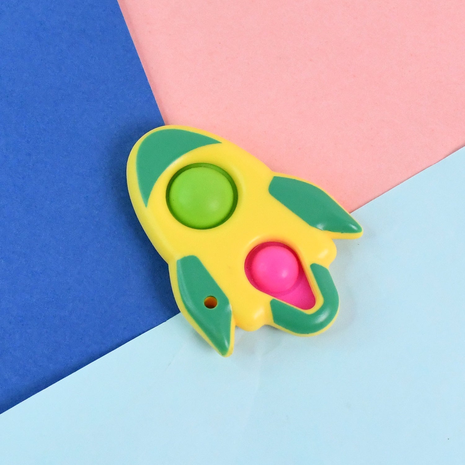 Close-up of silicone bubbles being popped on rocket fidget keychain toy