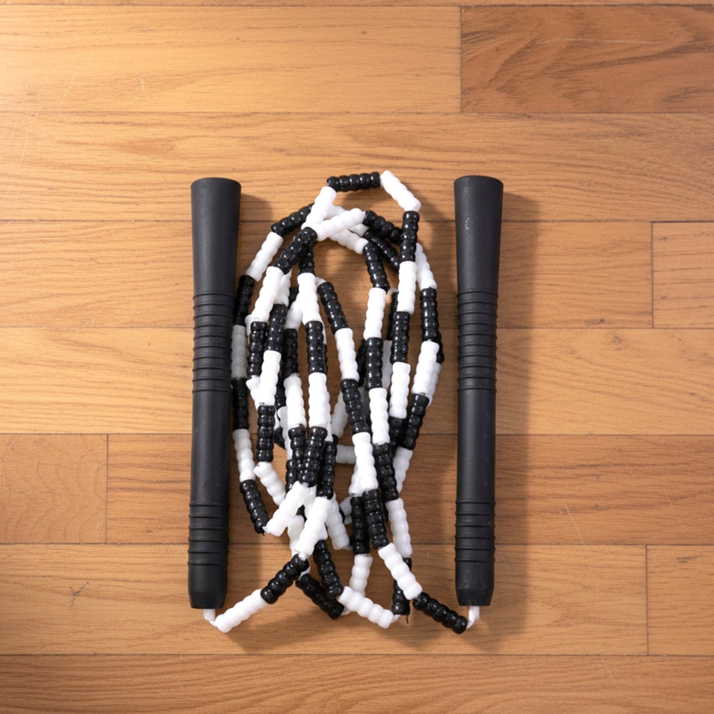 Neutral background image of fitness gear including skipping rope