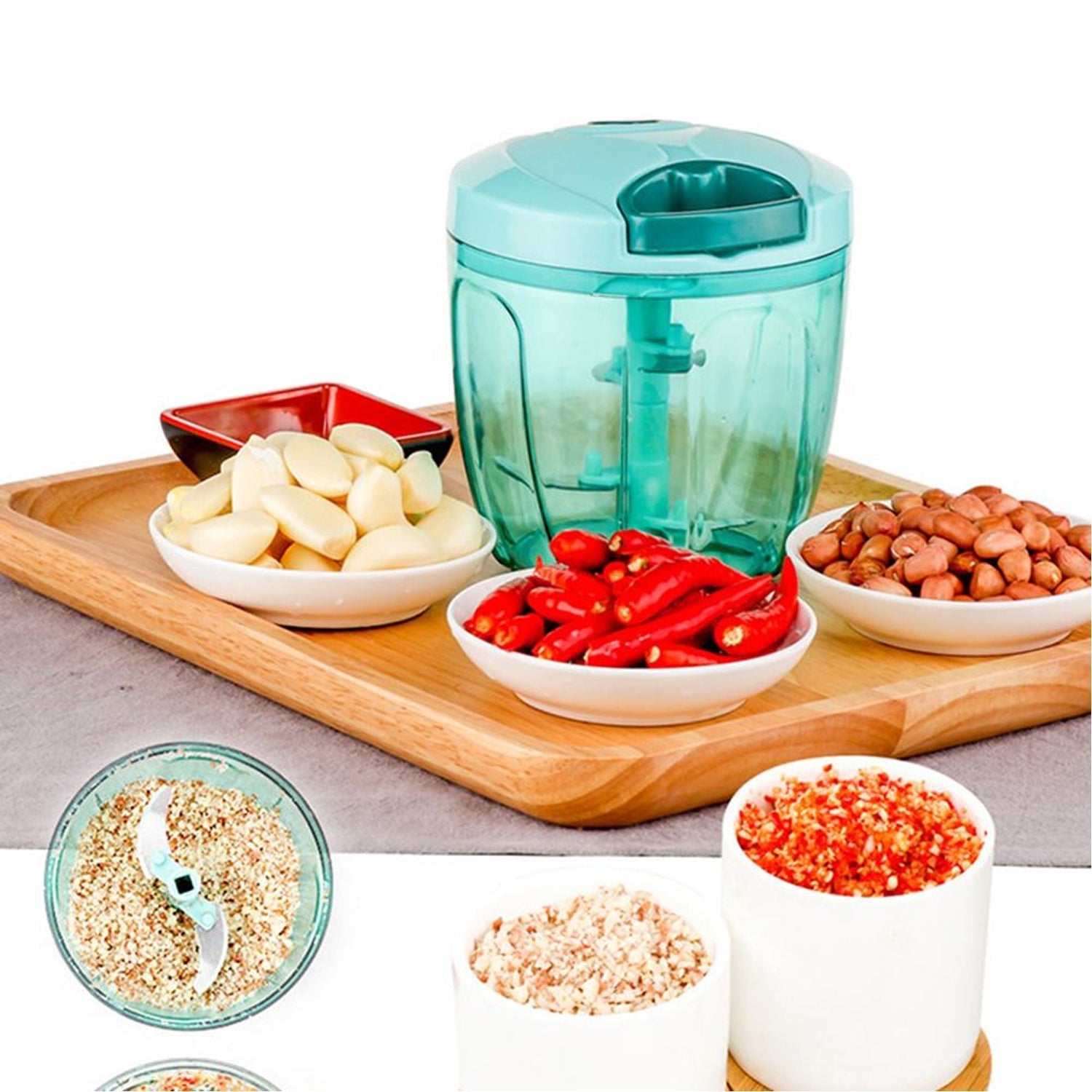 Top view of the teal manual pull-string food chopper with its sharp, multi-blade design.