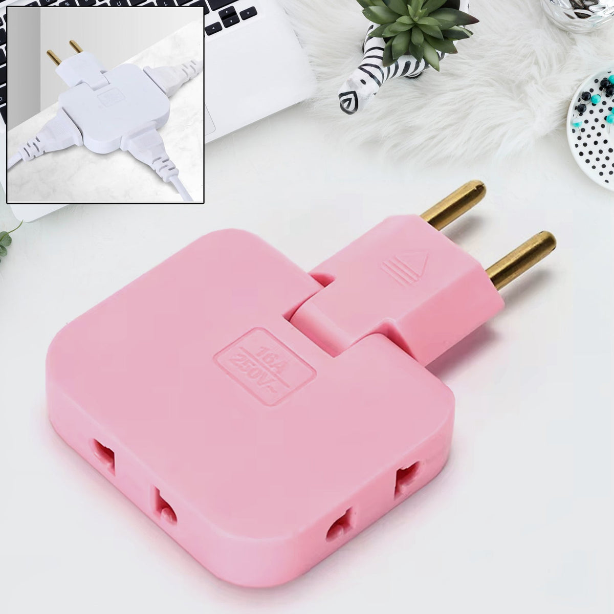 Pink 3-in-1 foldable wall plug adapter on a desk with a laptop and plant. Inset shows a white version with three cords