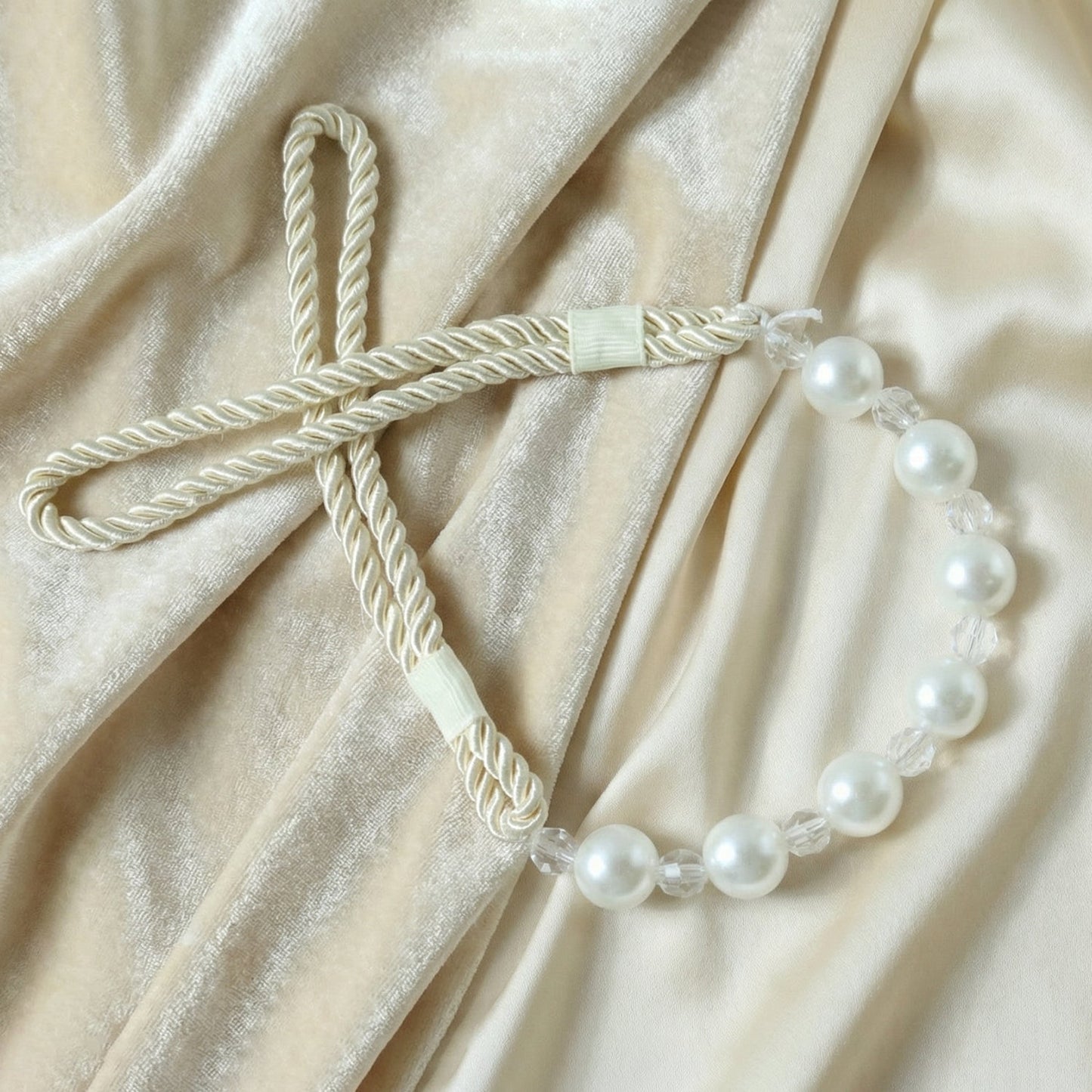 Stylish window drapery tieback featuring pearl beads