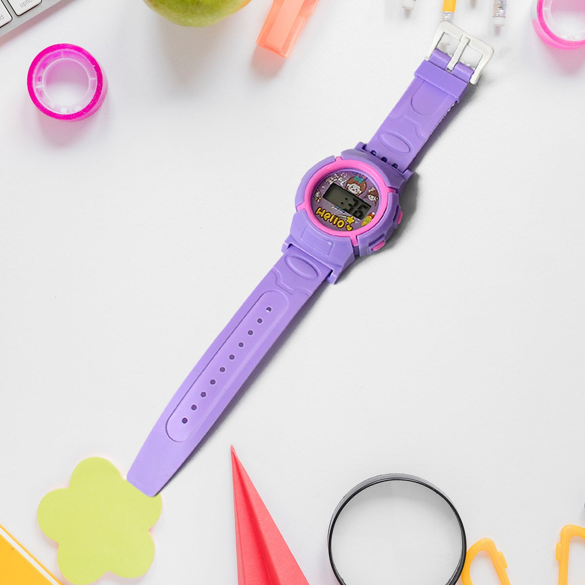 A purple digital watch with a pink trim and cartoon display, lying on a white surface with colorful office supplies 