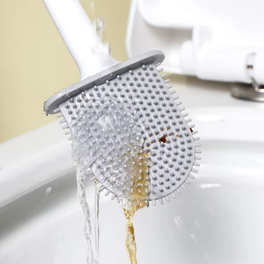 Silicone toilet brush with holder mounted on a clean bathroom wall.
