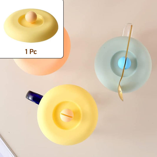 A Tidy Table Silicone Cup Lid in grey, providing an airtight, dust-proof seal on a ceramic mug.