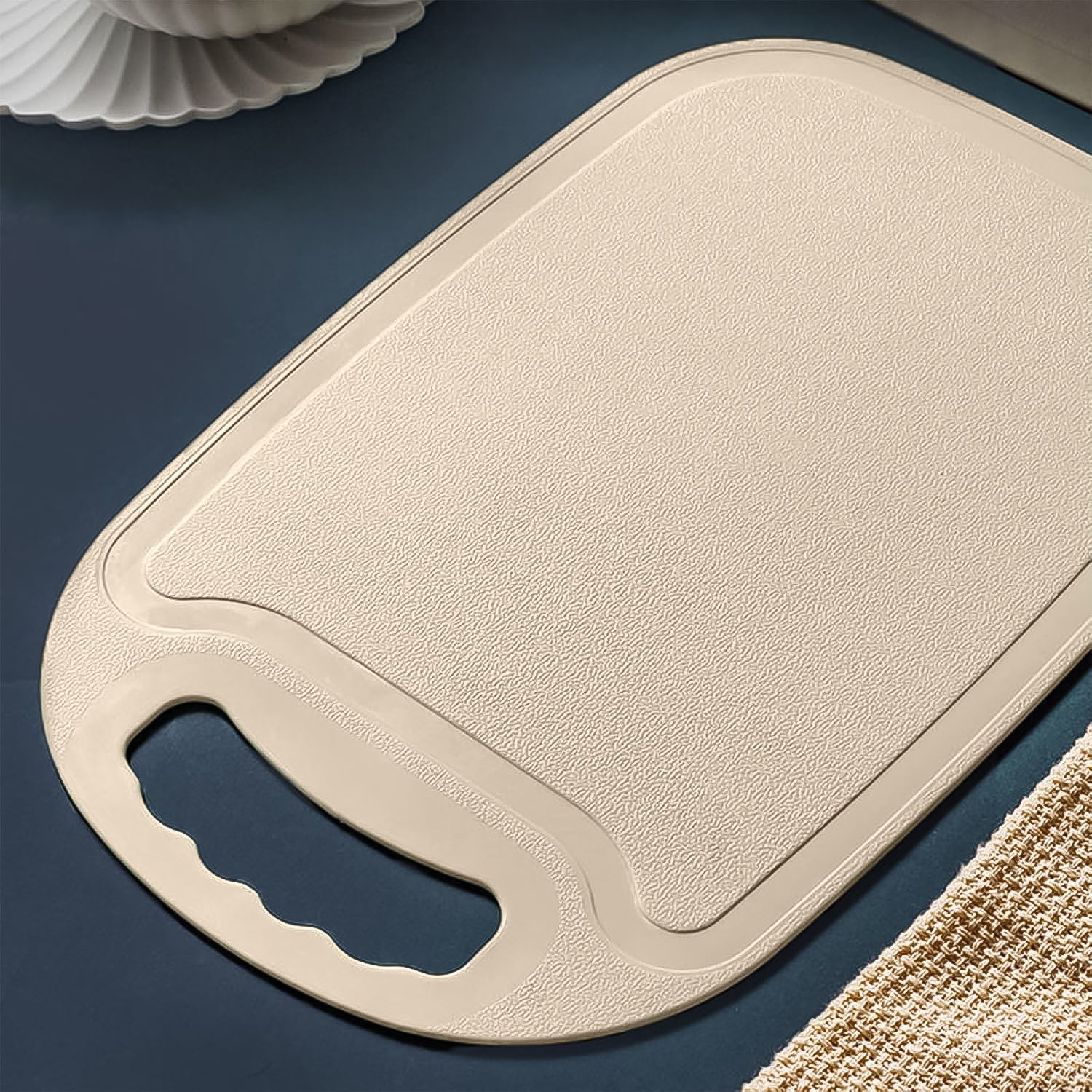 Kitchen plastic chopping board showing smooth surface and handle