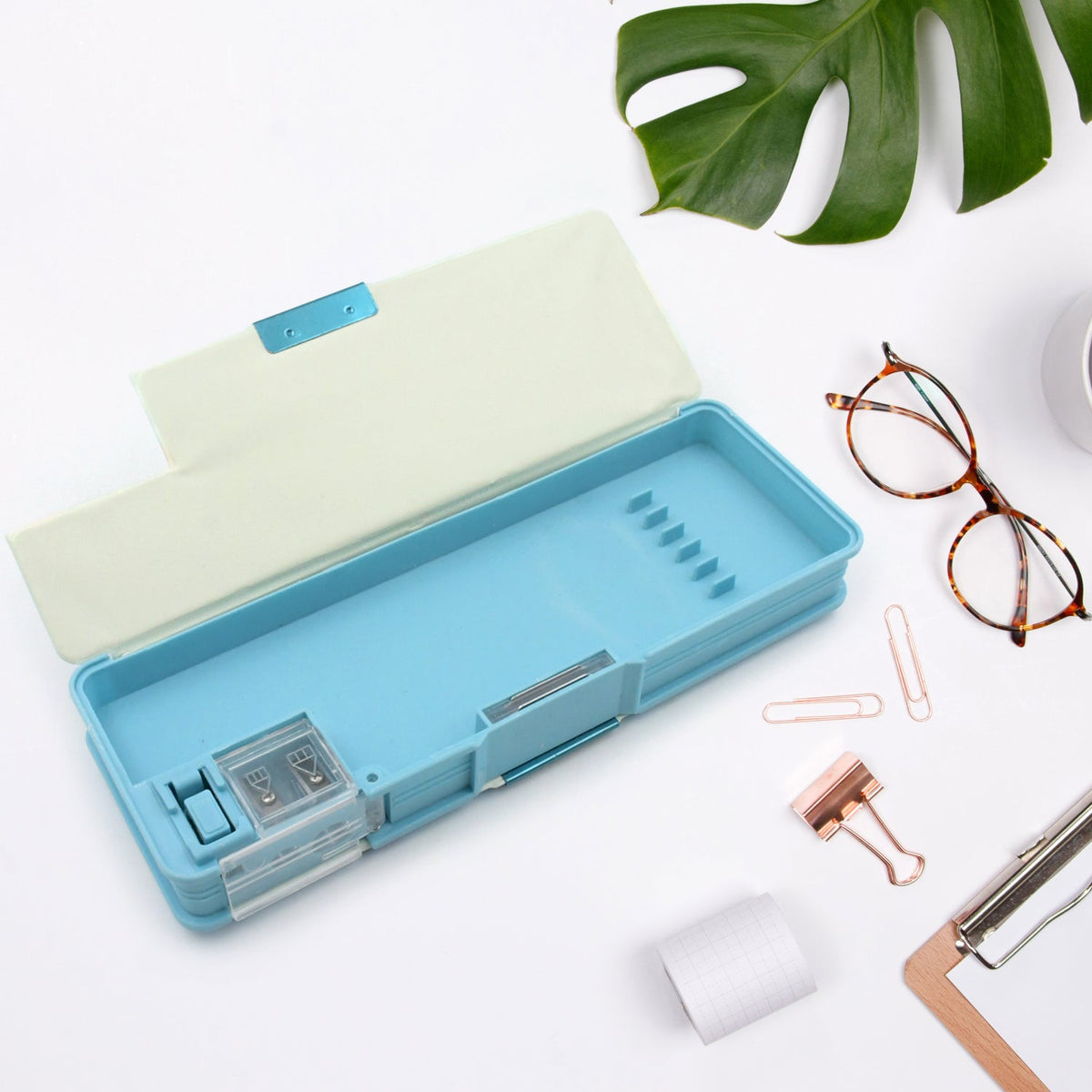 Two-compartment plastic stationery box with sharpener, ideal for separating different types of school supplies.