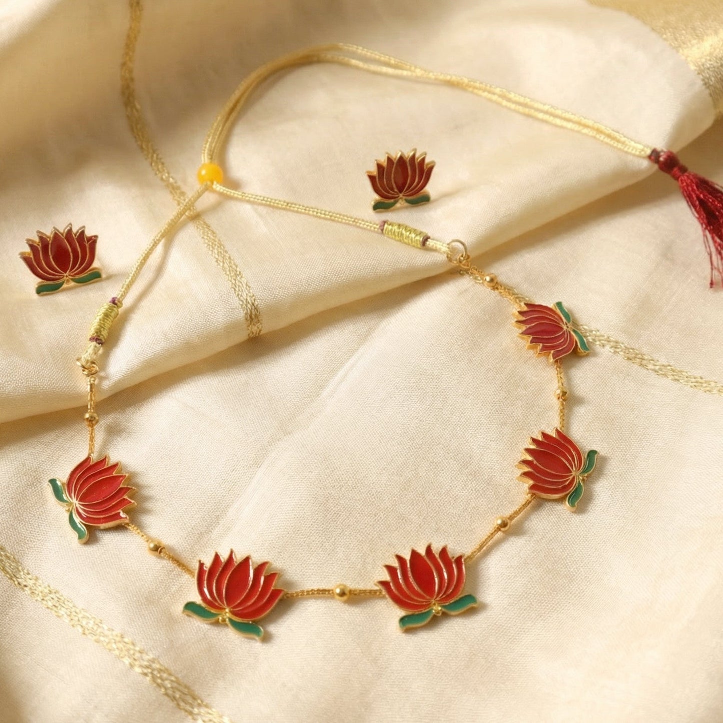 Side view of red lotus necklace emphasizing thread closure