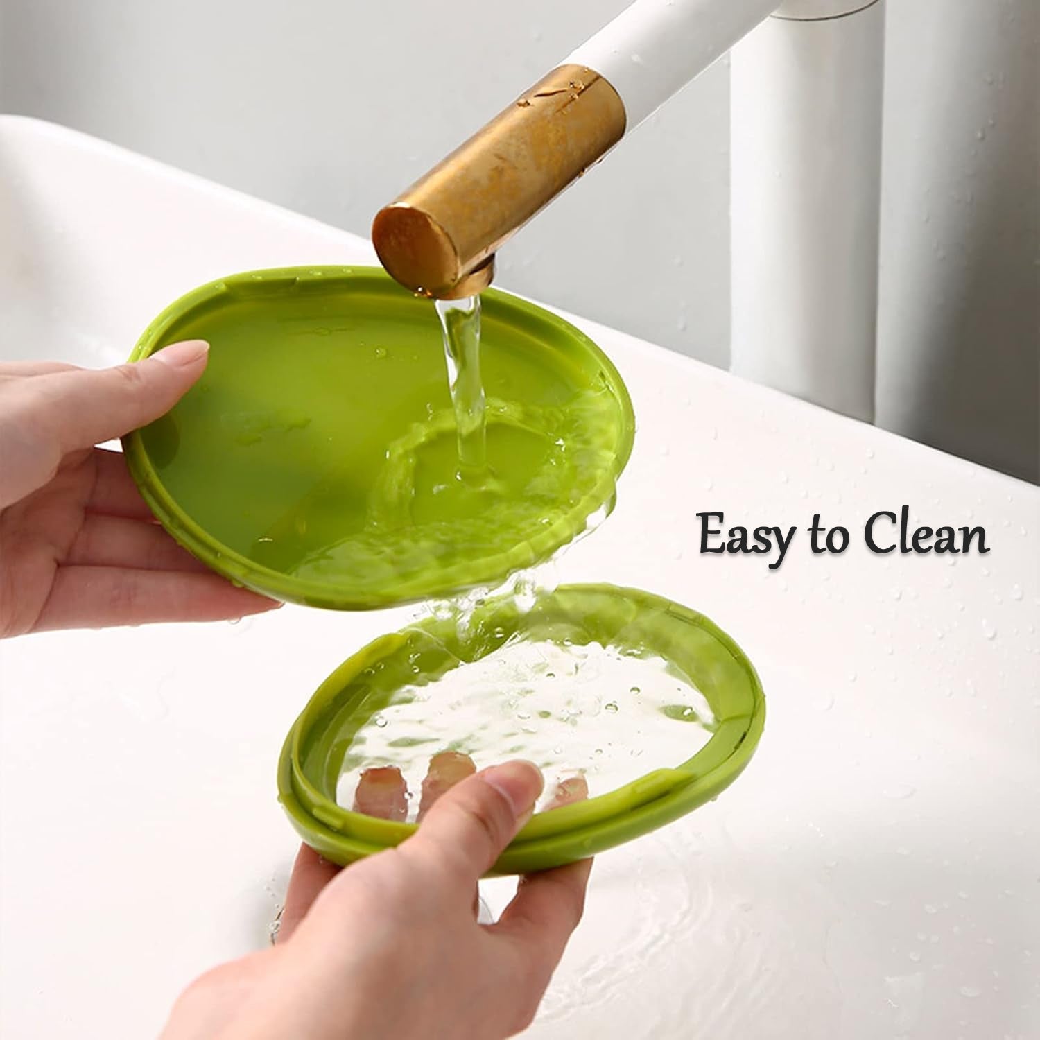 A person slices an avocado on a wooden board next to an open green avocado saver container.