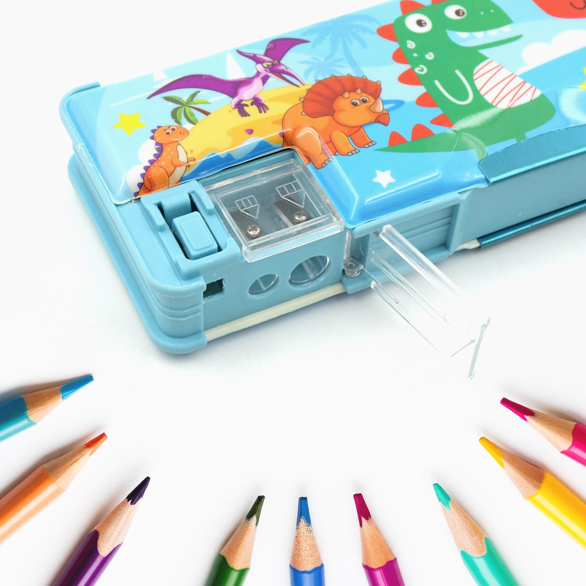 Close-up of a blue dinosaur pencil case with its sharpener compartment open, surrounded by colored pencils.