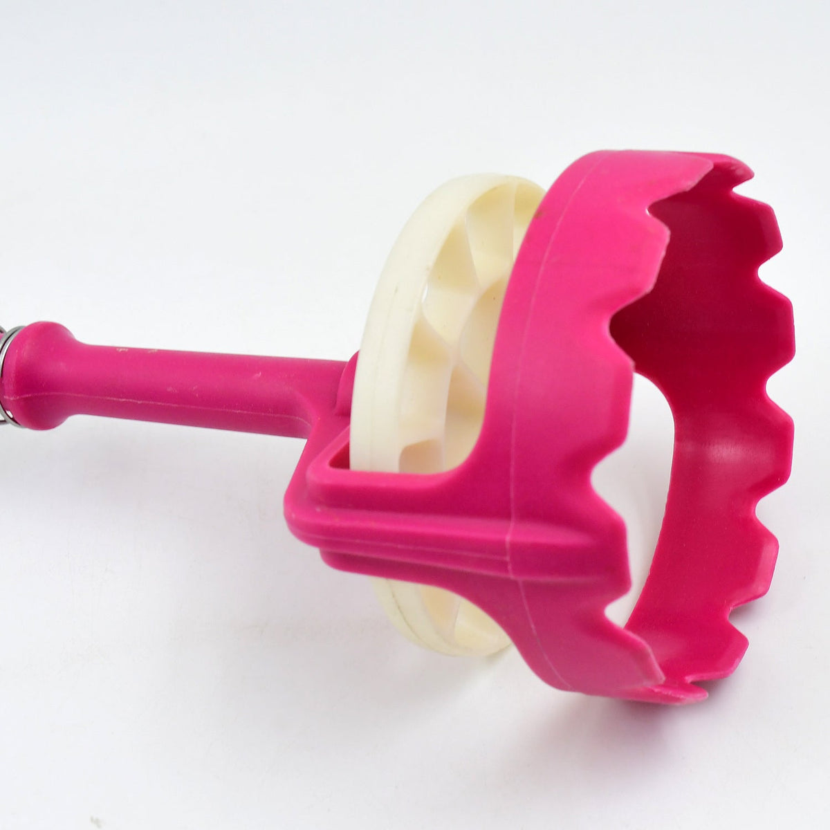Close-up of the pink and white mashing head of the tool against a plain white background.