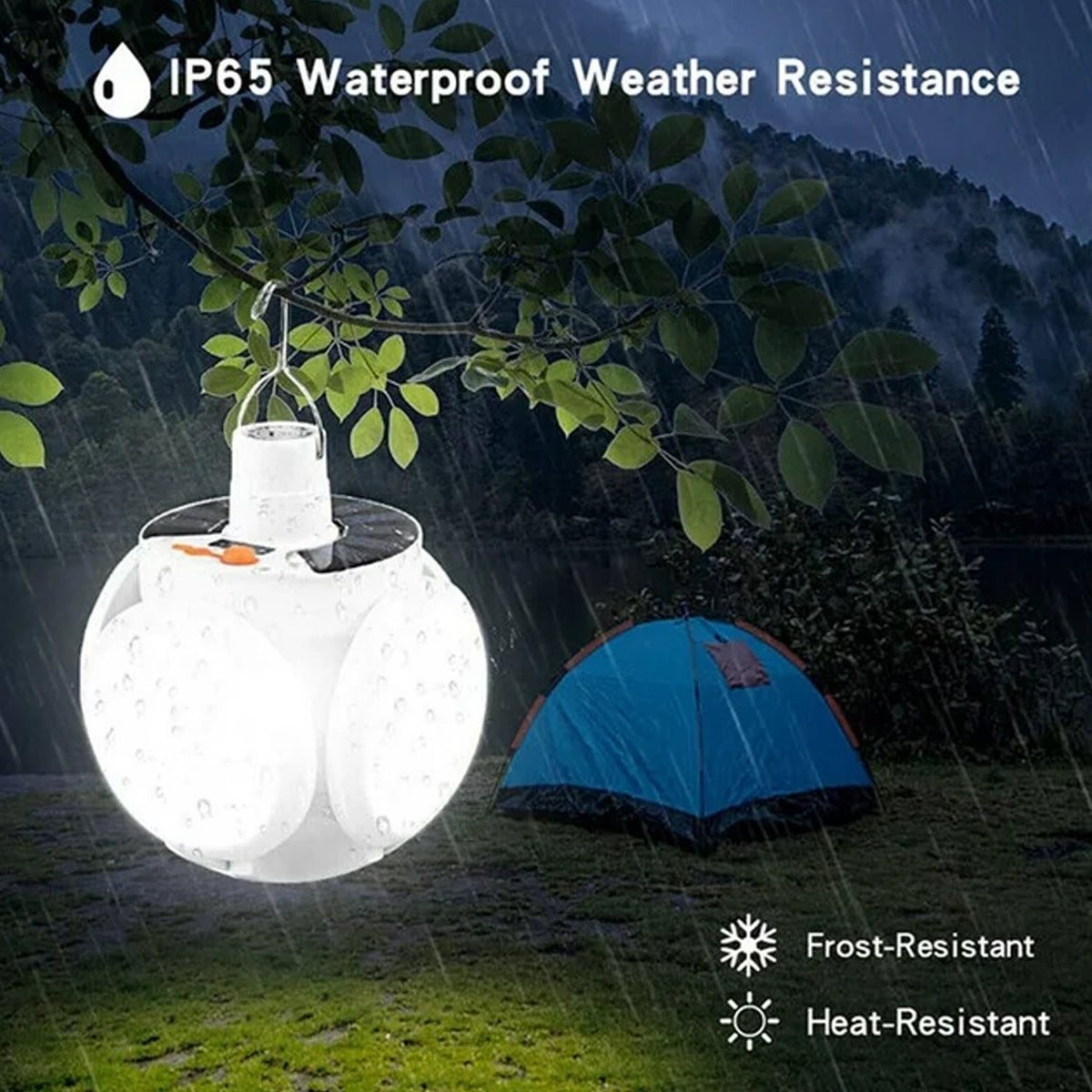 The white camping light hangs from a tree branch in the rain, illuminating a nearby blue tent.