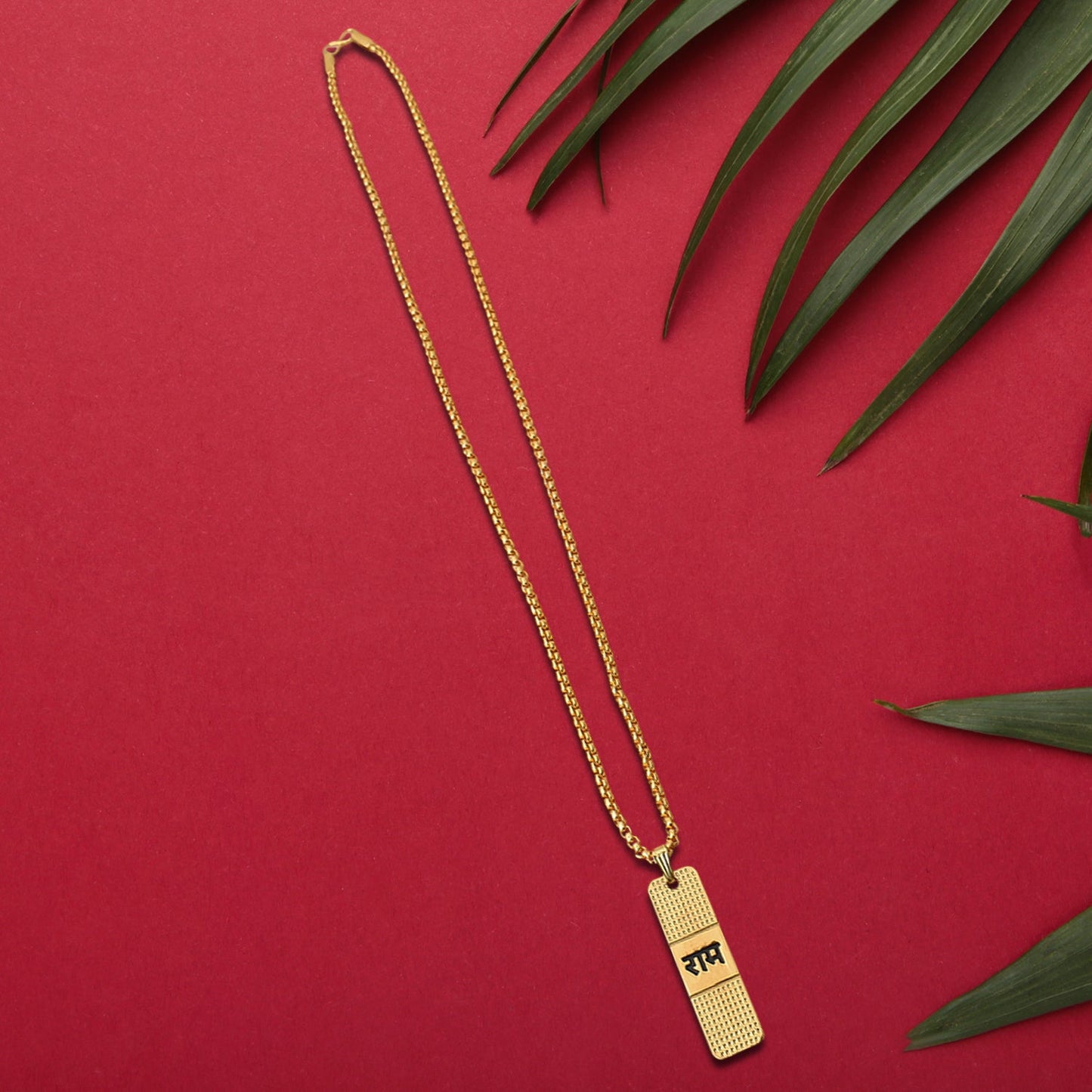 Elegant gold-plated Ram Naam pendant and chain displayed artistically.