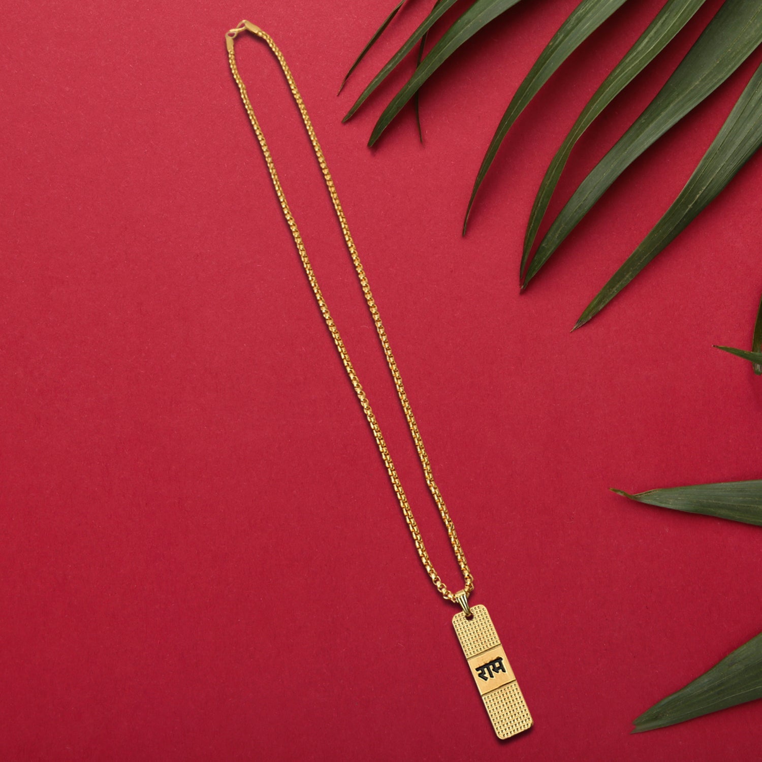 Elegant gold-plated Ram Naam pendant and chain displayed artistically.
