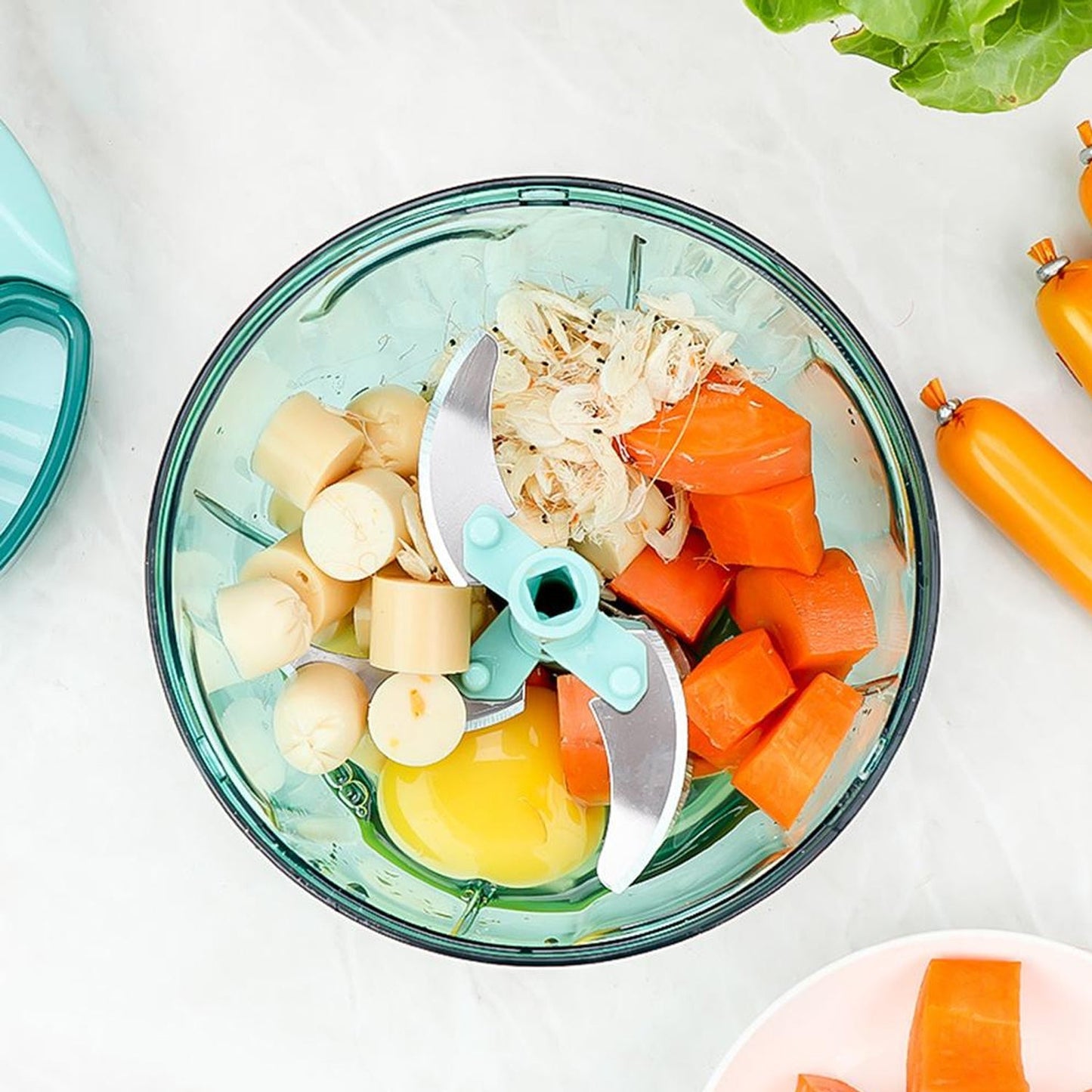 Extra sharp 5-blade stainless steel teal manual pull-string food chopper for quick meal prep.