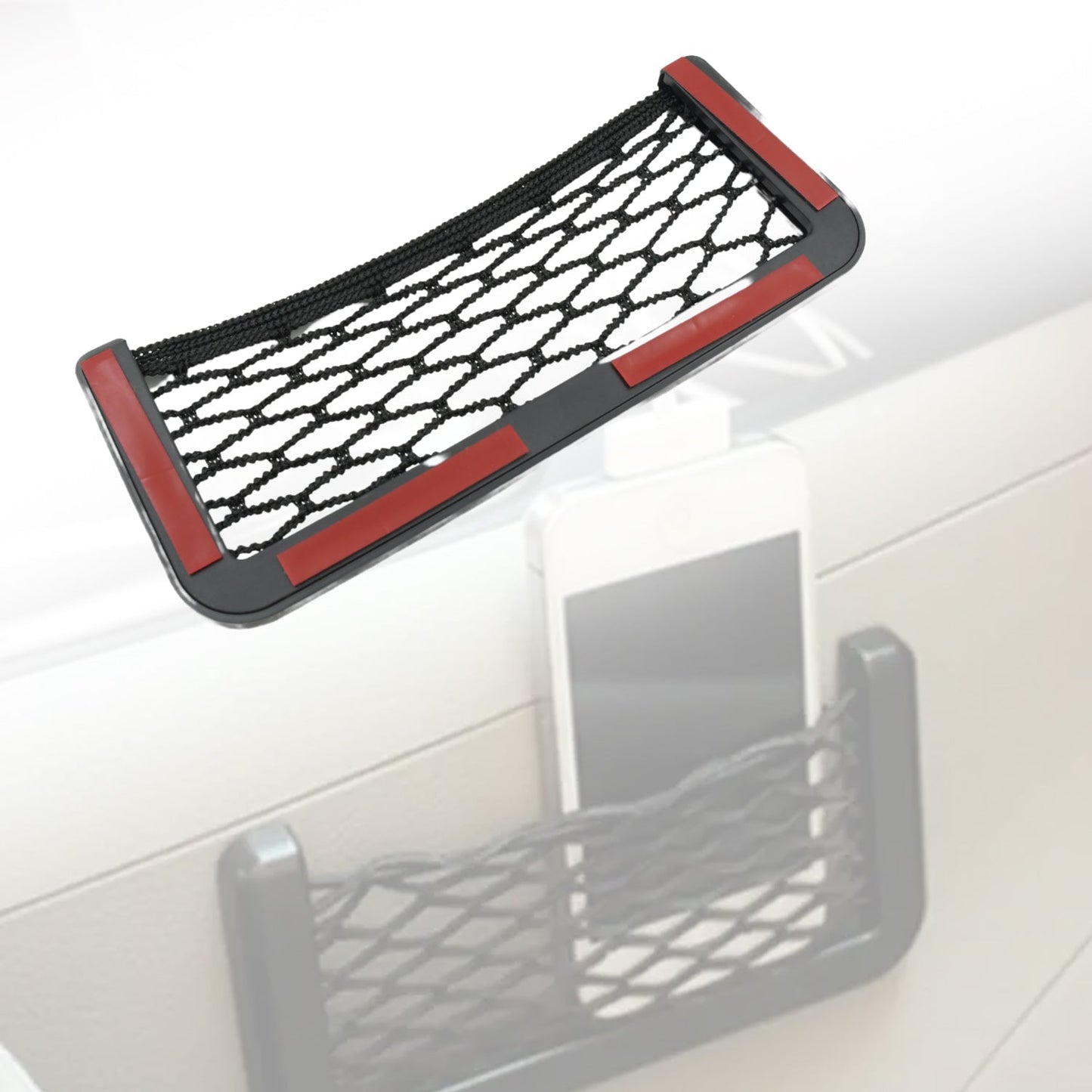 A black mesh car organizer with red adhesive strips on the back, holding a white smartphone.