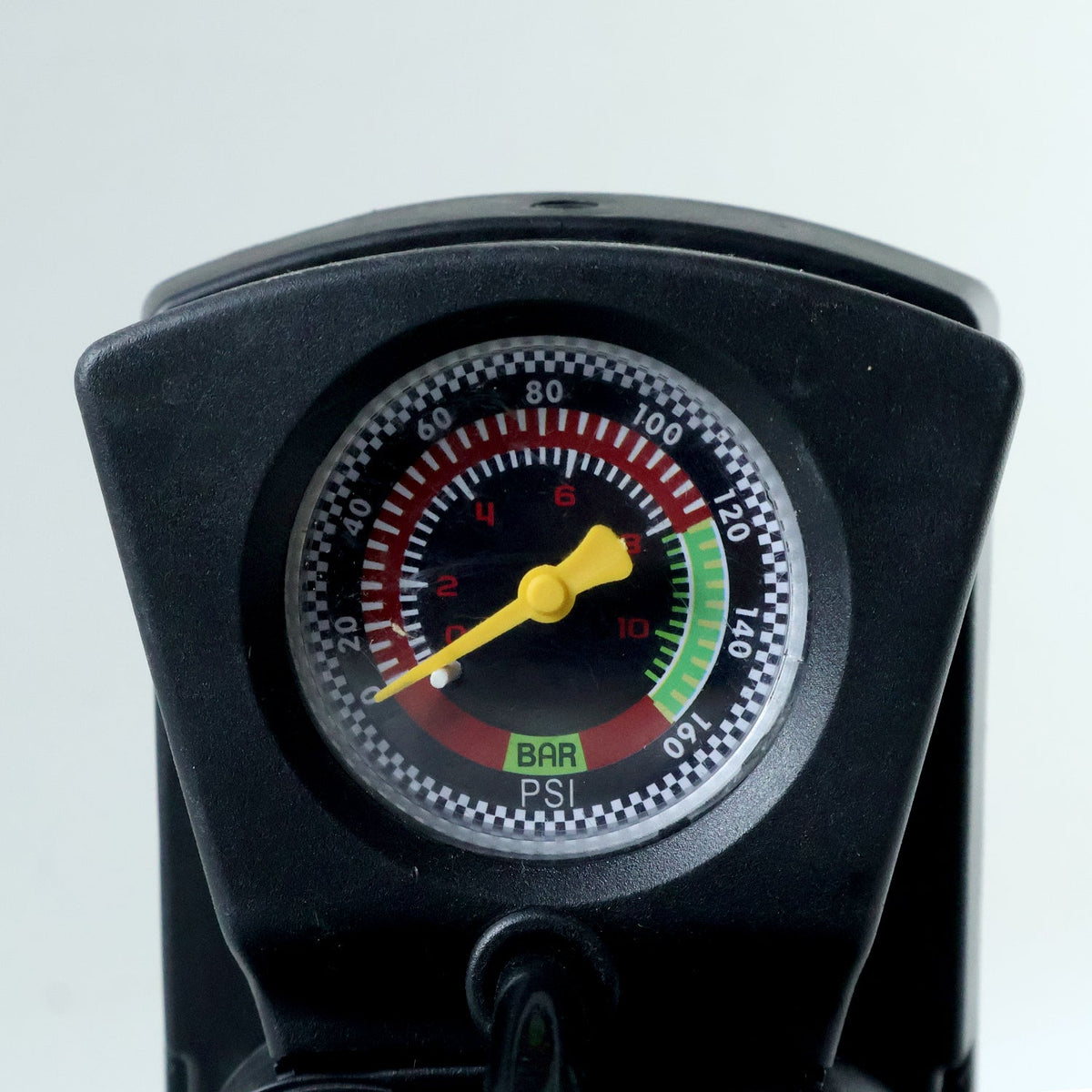 A close-up of the black foot pump's pressure gauge, showing readings in BAR and PSI.
