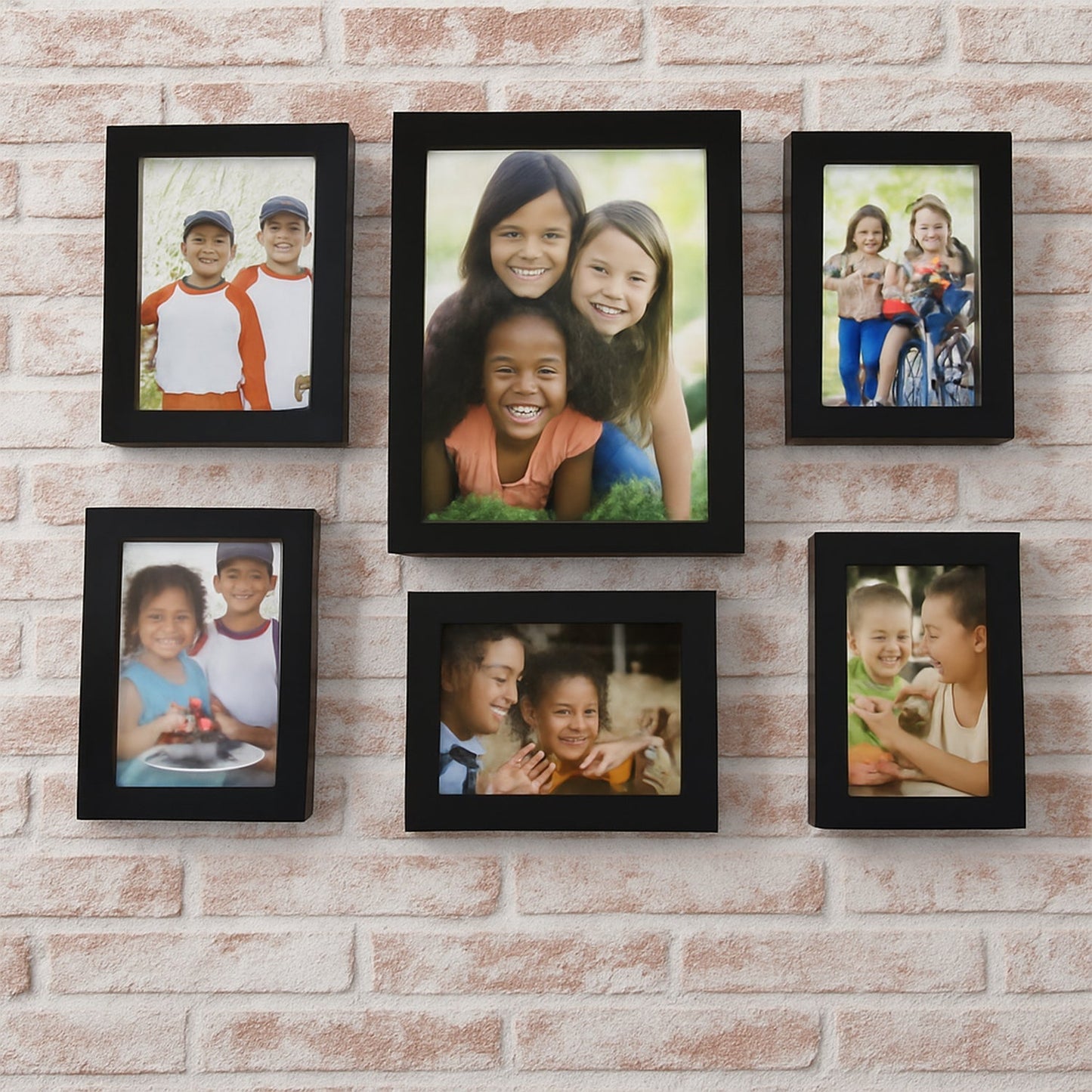Black 12 photo frame set displayed with photos on a living room wall